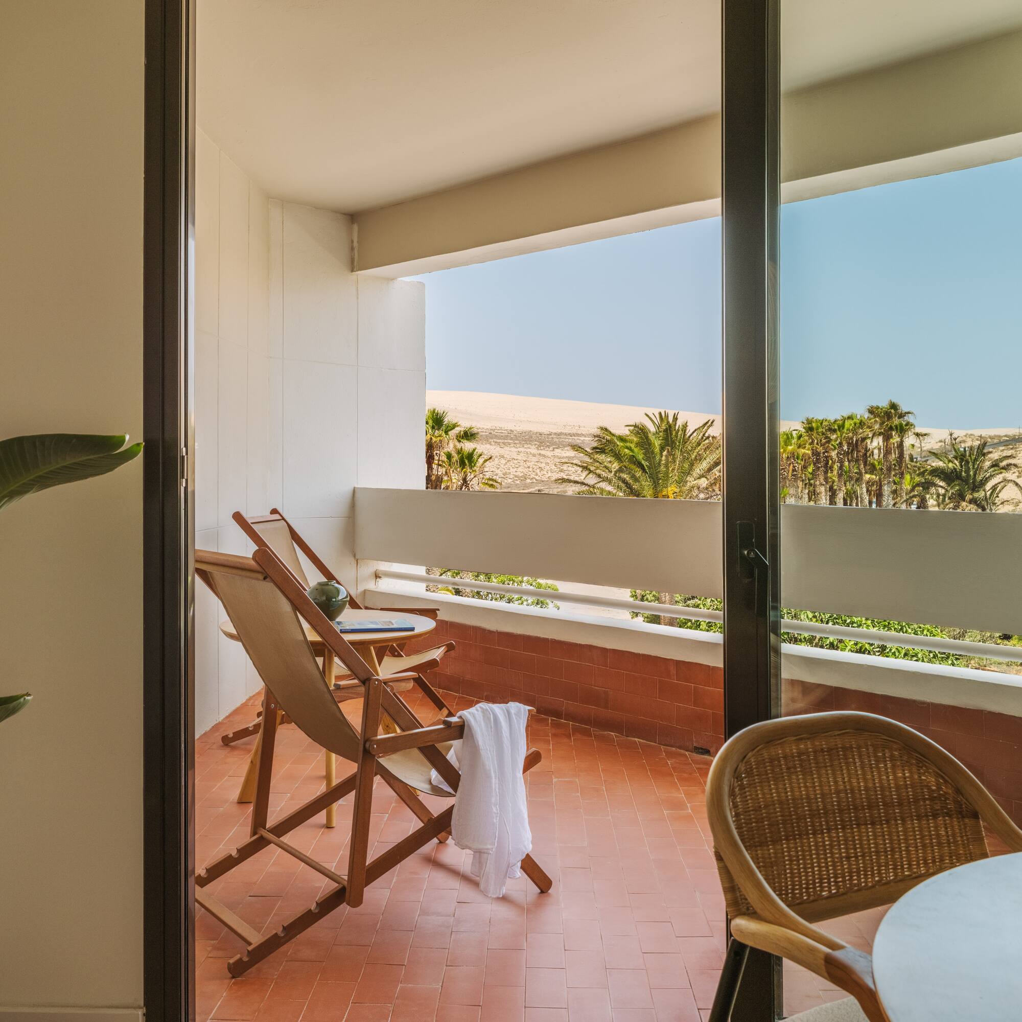 a chair and table on a balcony