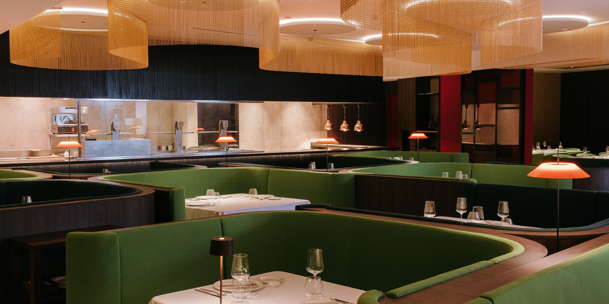 a restaurant with green booth seating and green couches