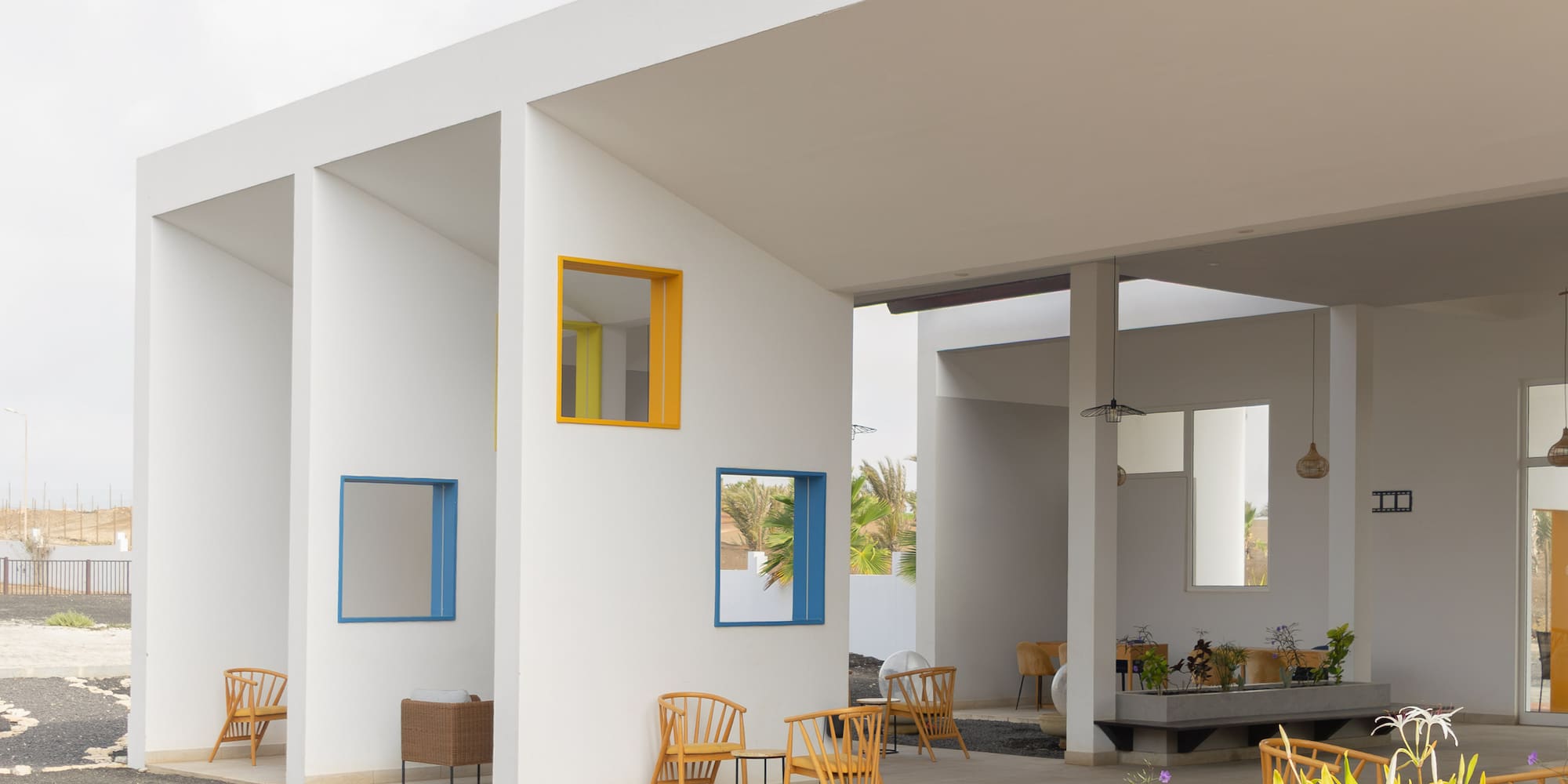 a white building with chairs and tables