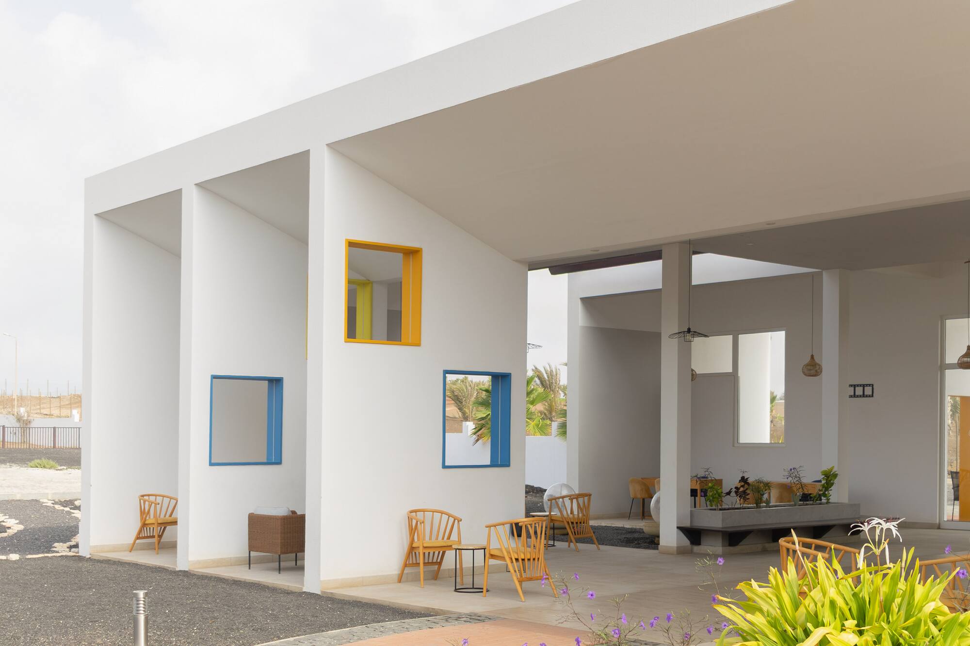 a white building with chairs and tables