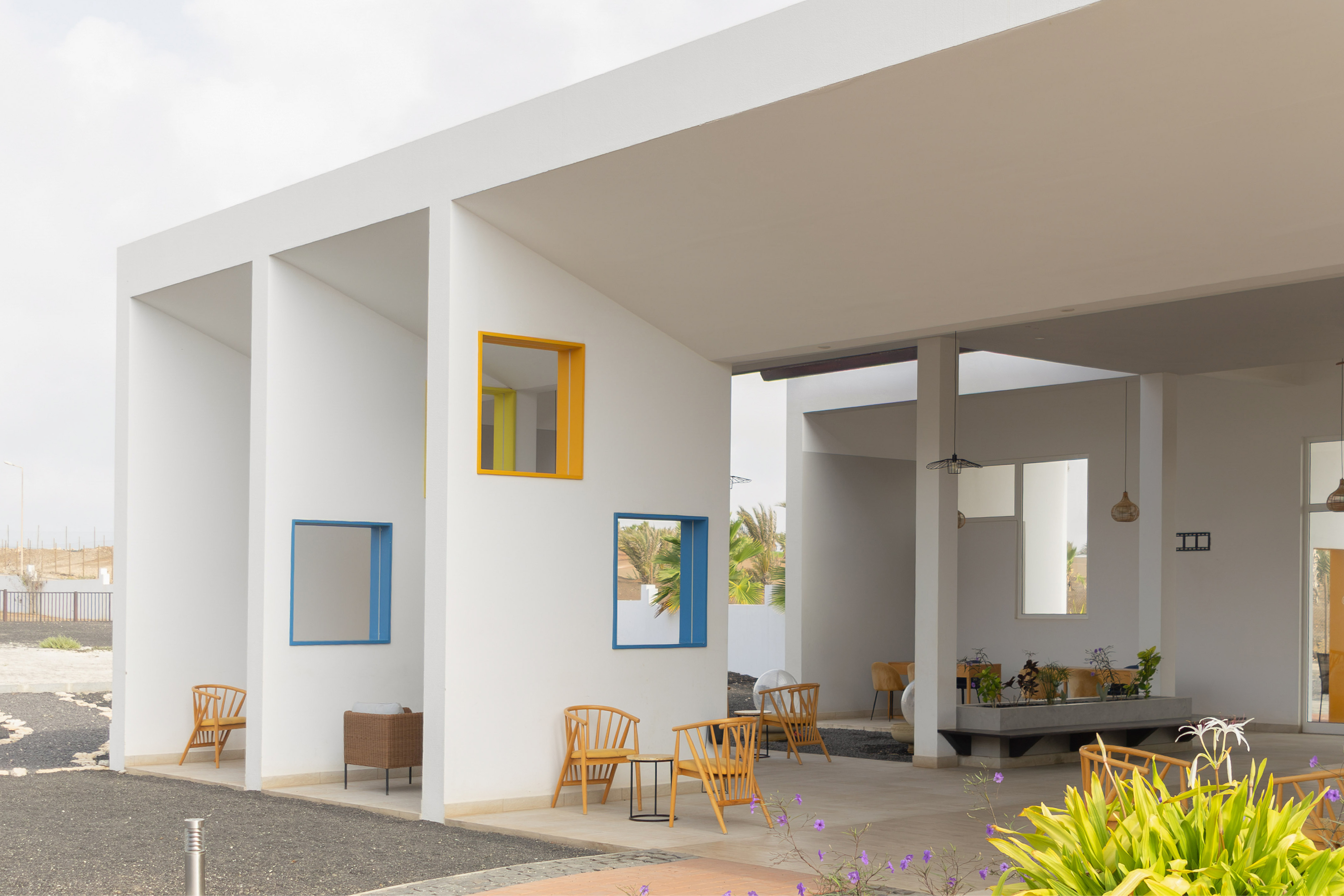 a white building with chairs and tables