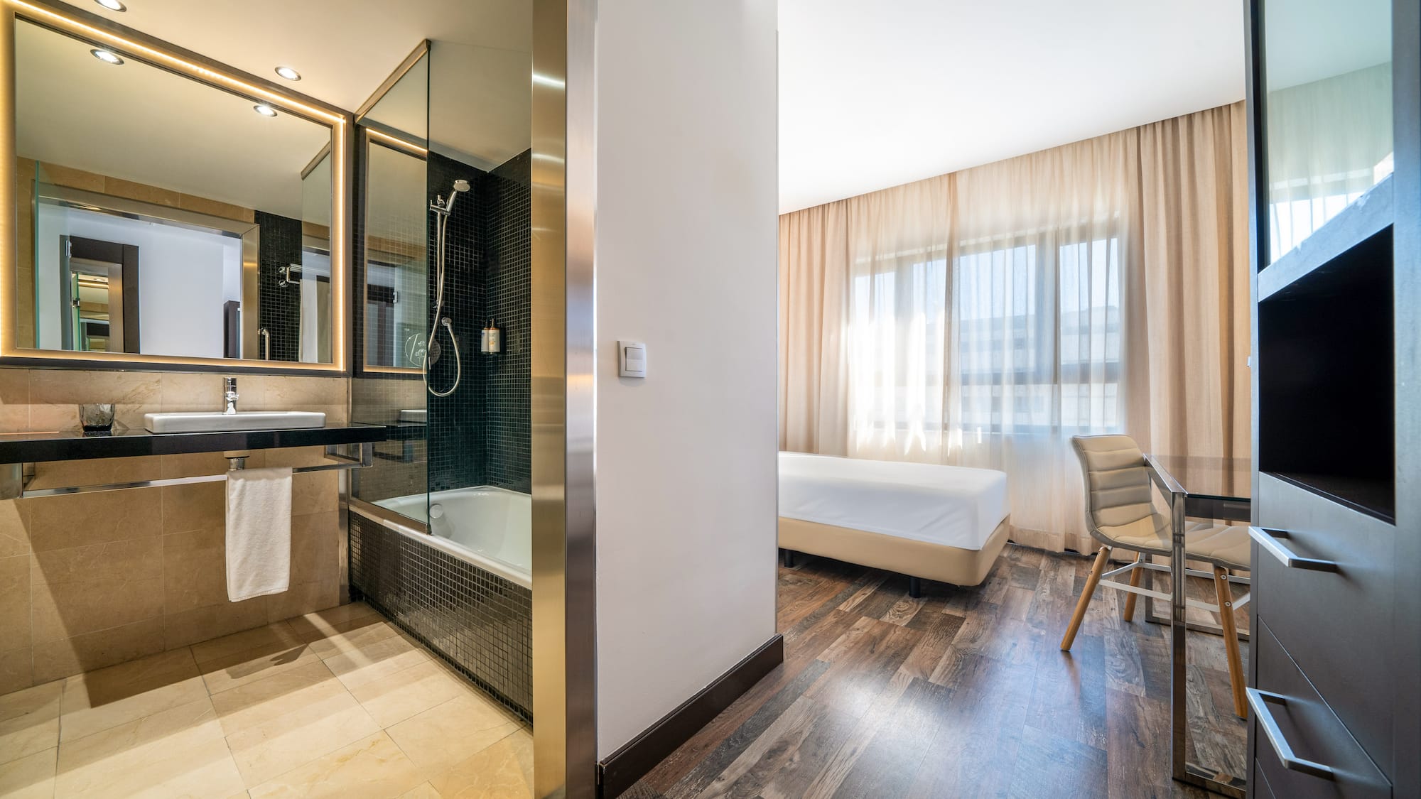 a room with a bed and a bathtub