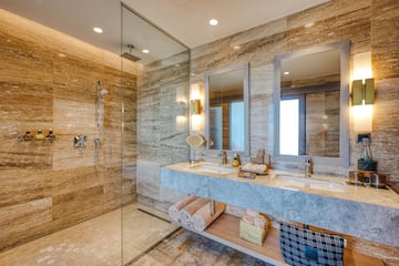 a bathroom with marble countertop and shower