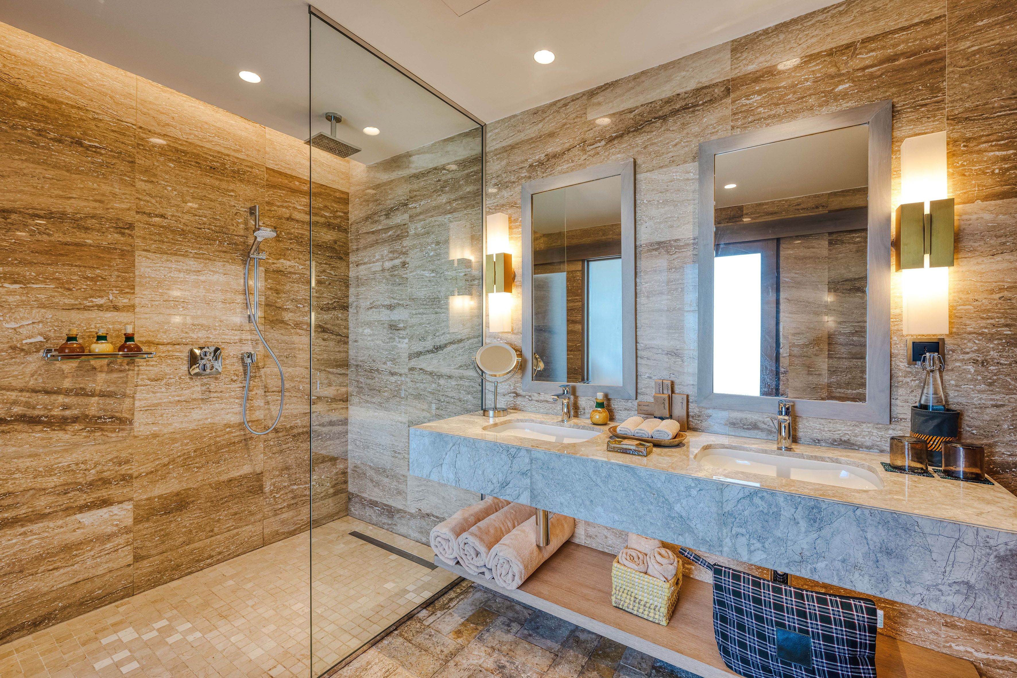 a bathroom with marble countertop and shower