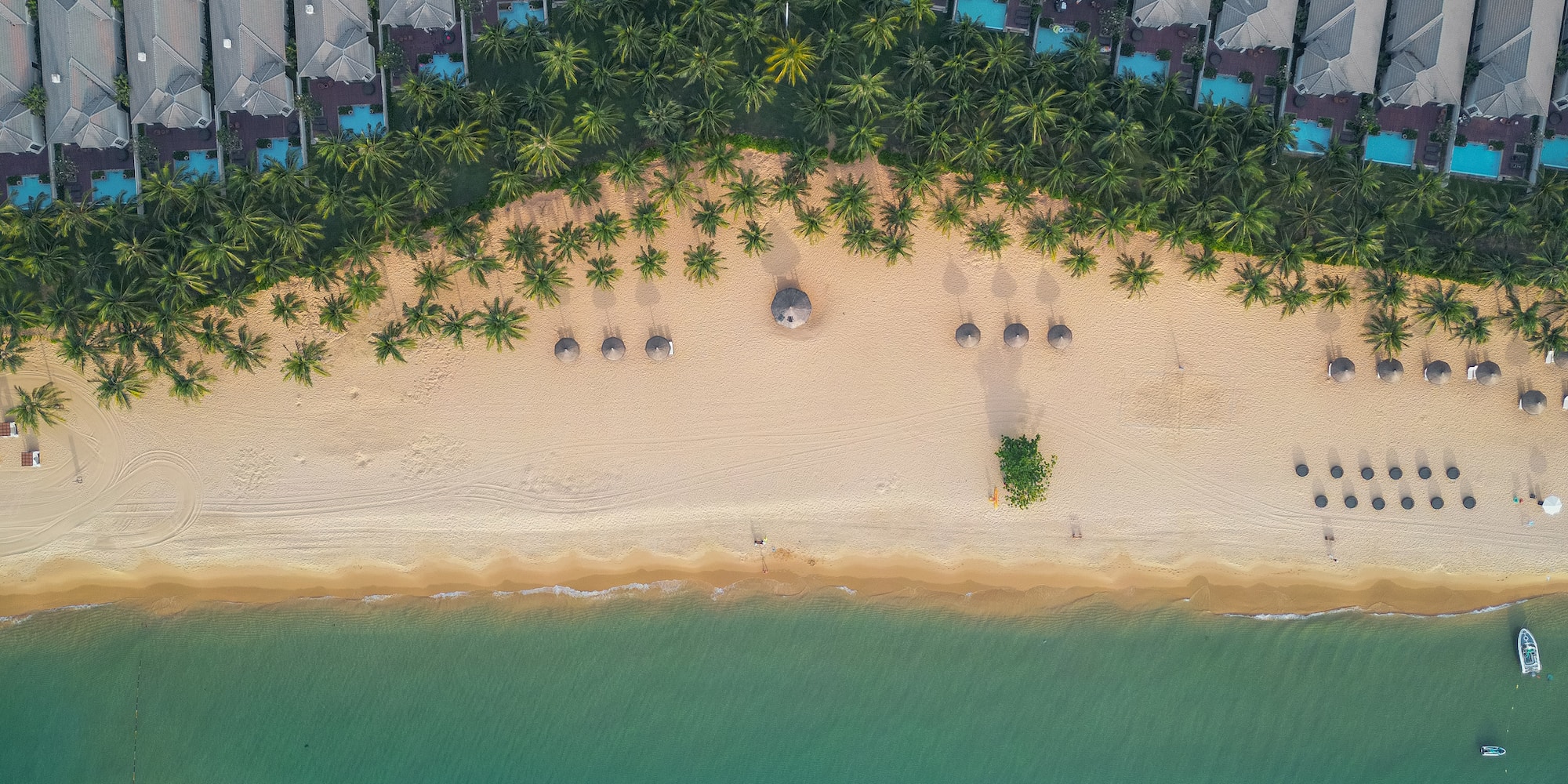 a beach with many buildings and a body of water