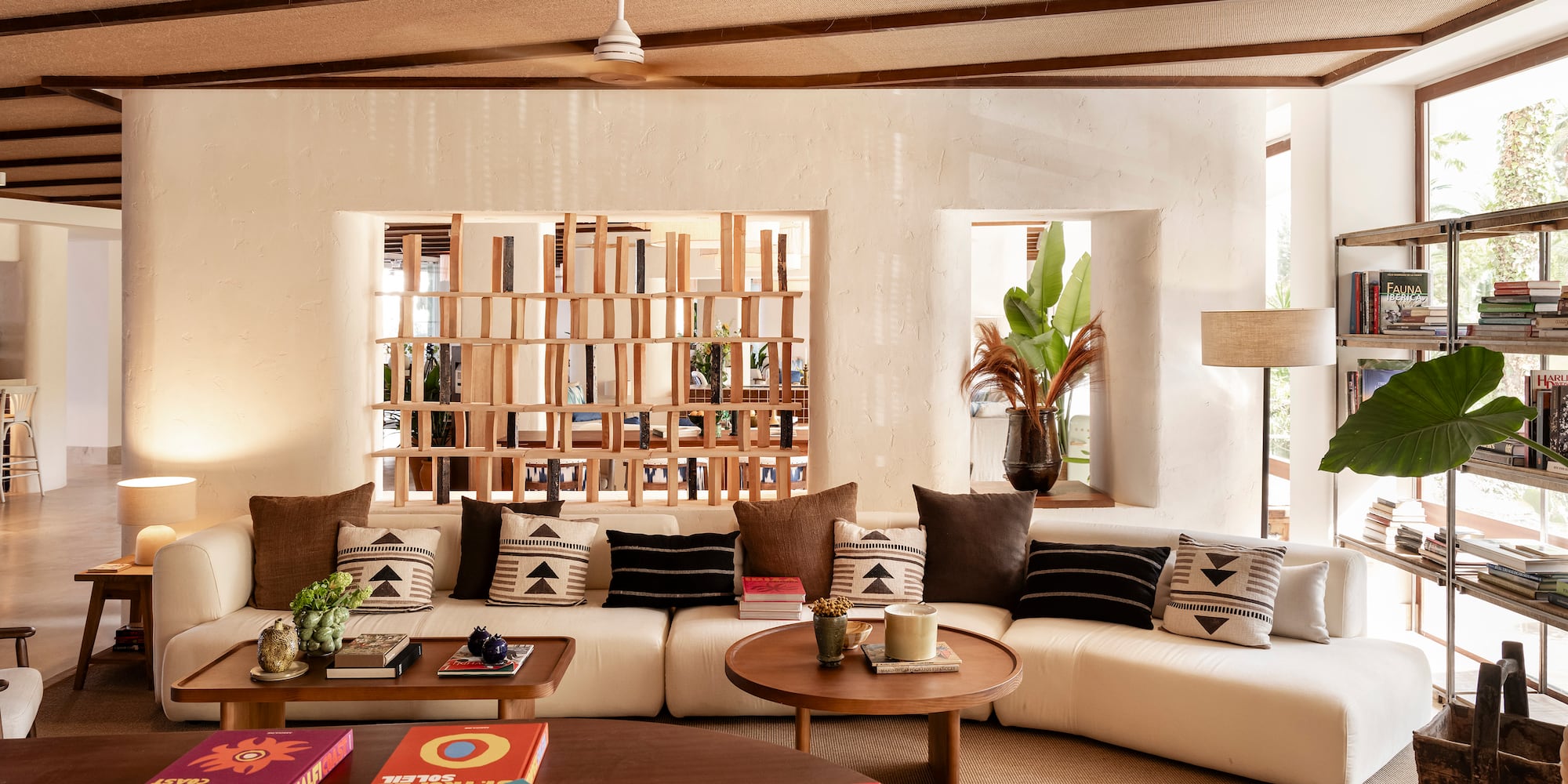 a living room with a white couch and coffee tables