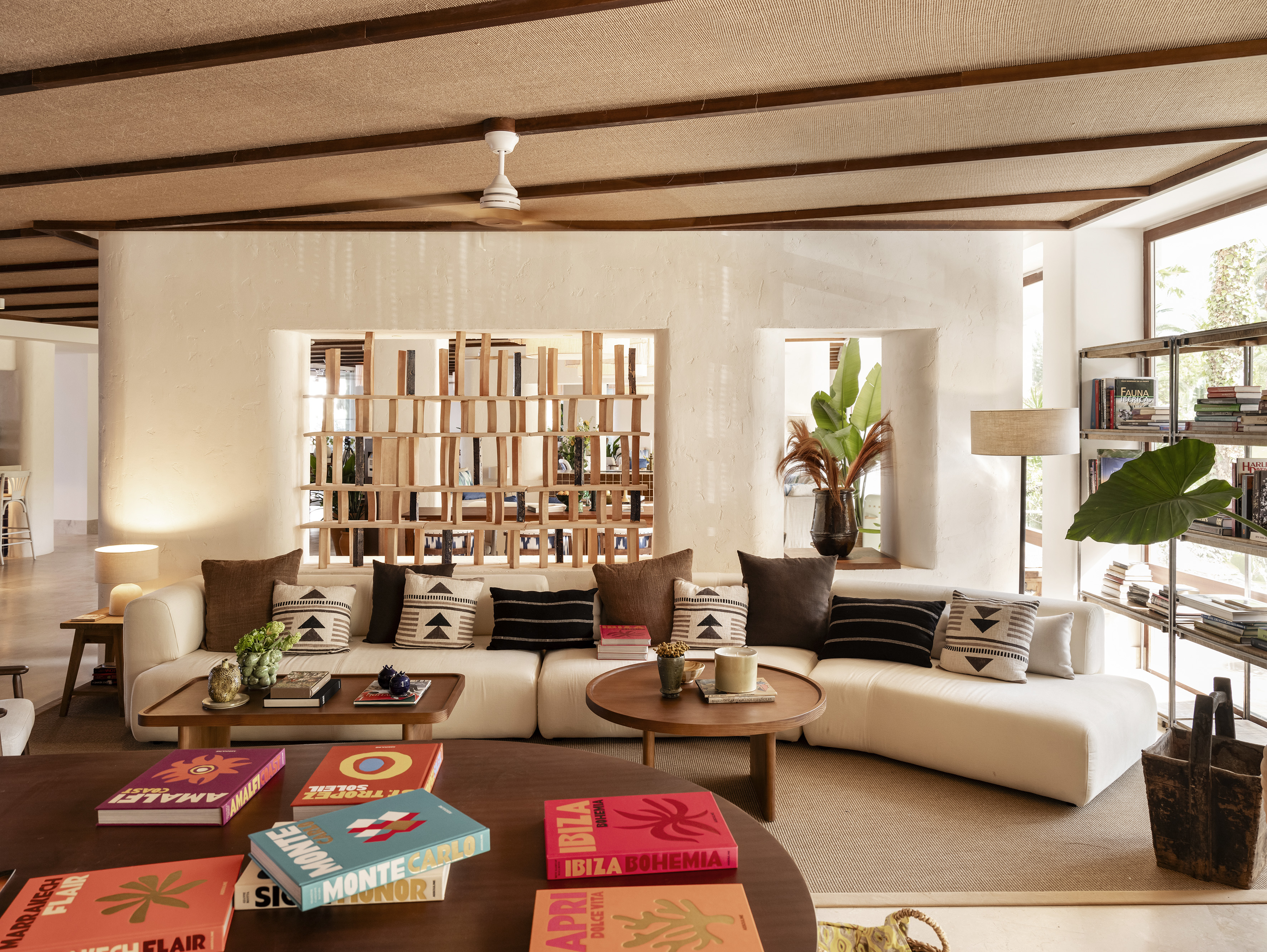 a living room with a white couch and coffee tables