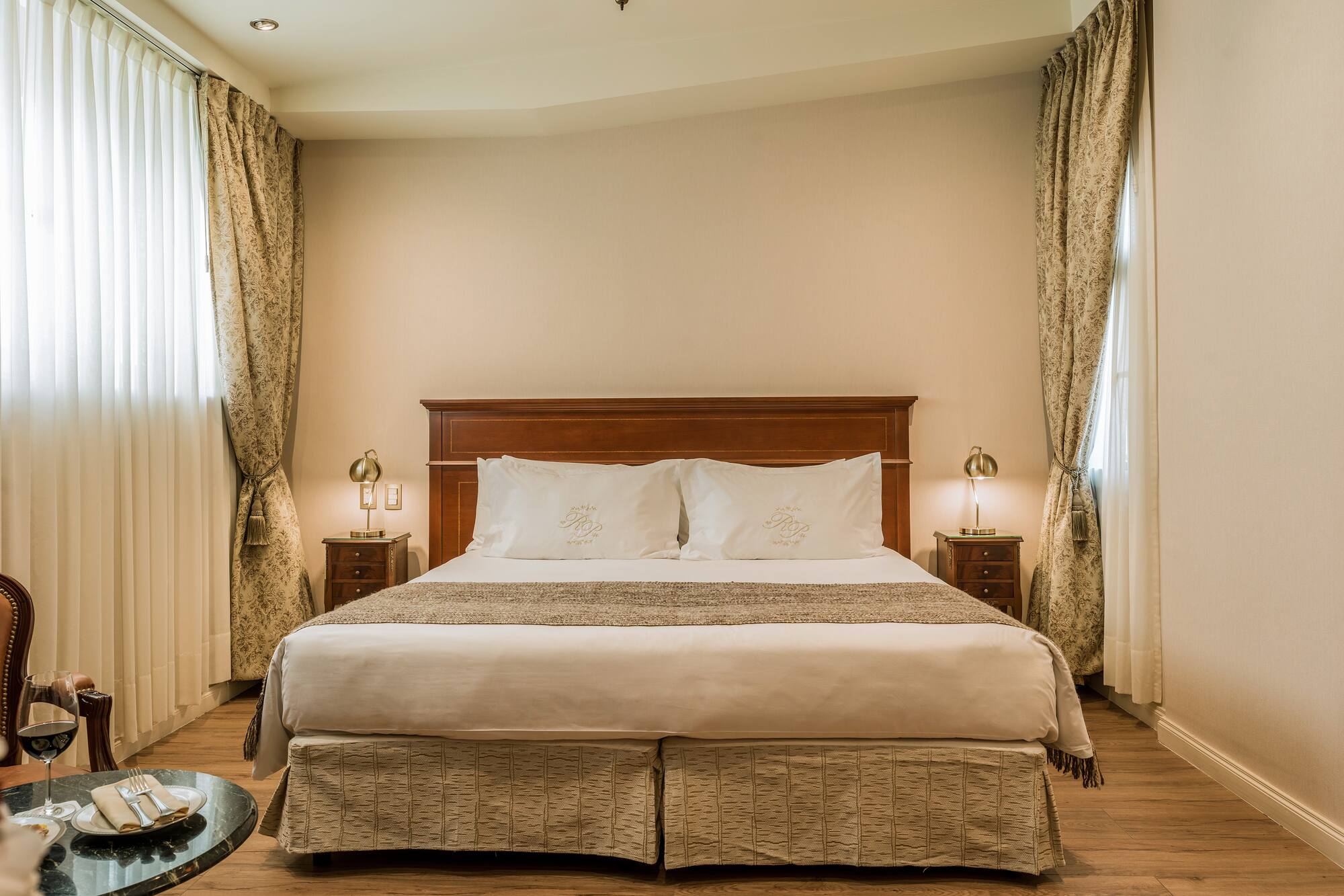 a bed with a wood headboard and a wood floor