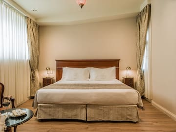 a bed with a wood headboard and a wood floor