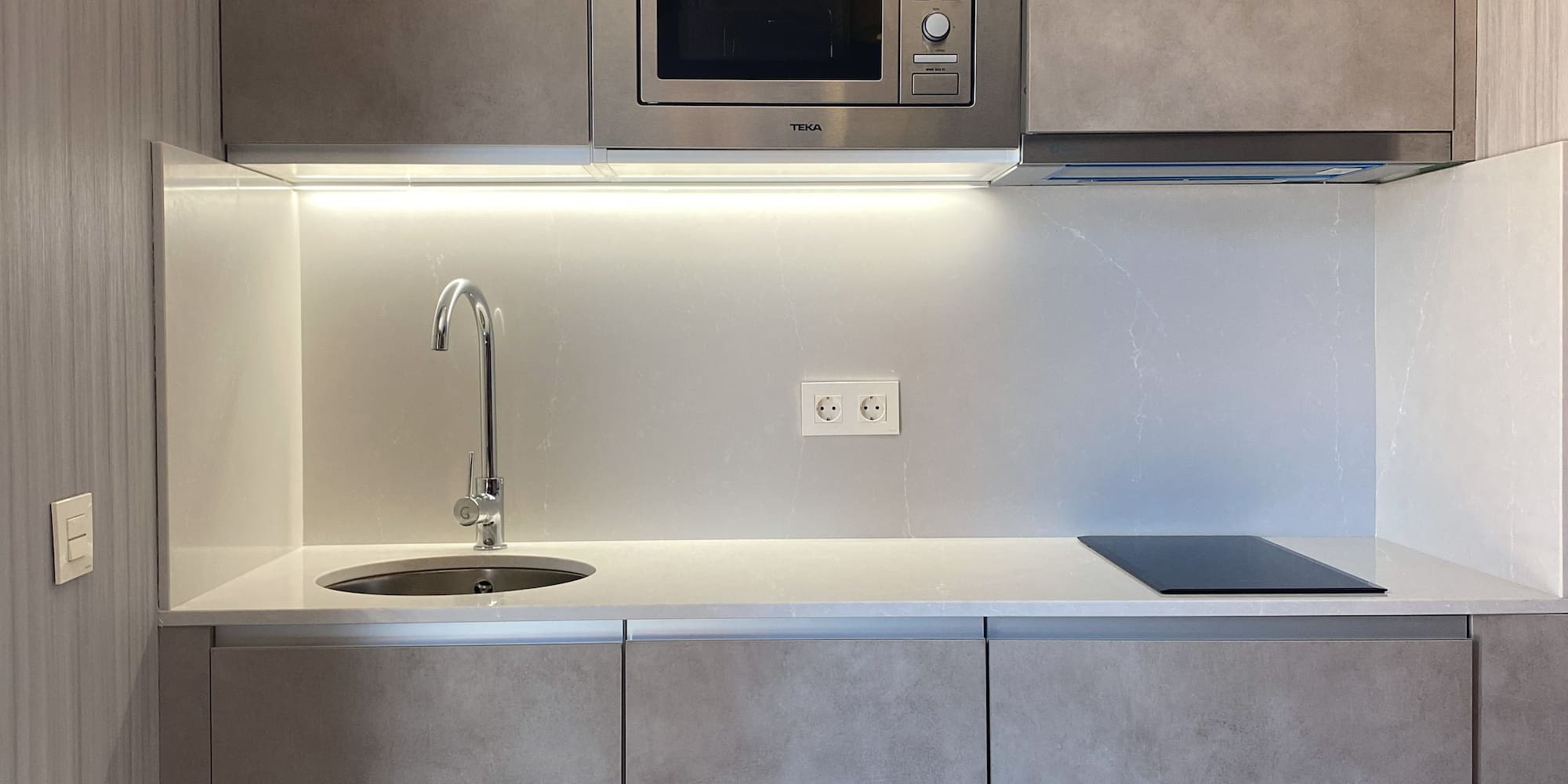 a kitchen with a microwave and sink