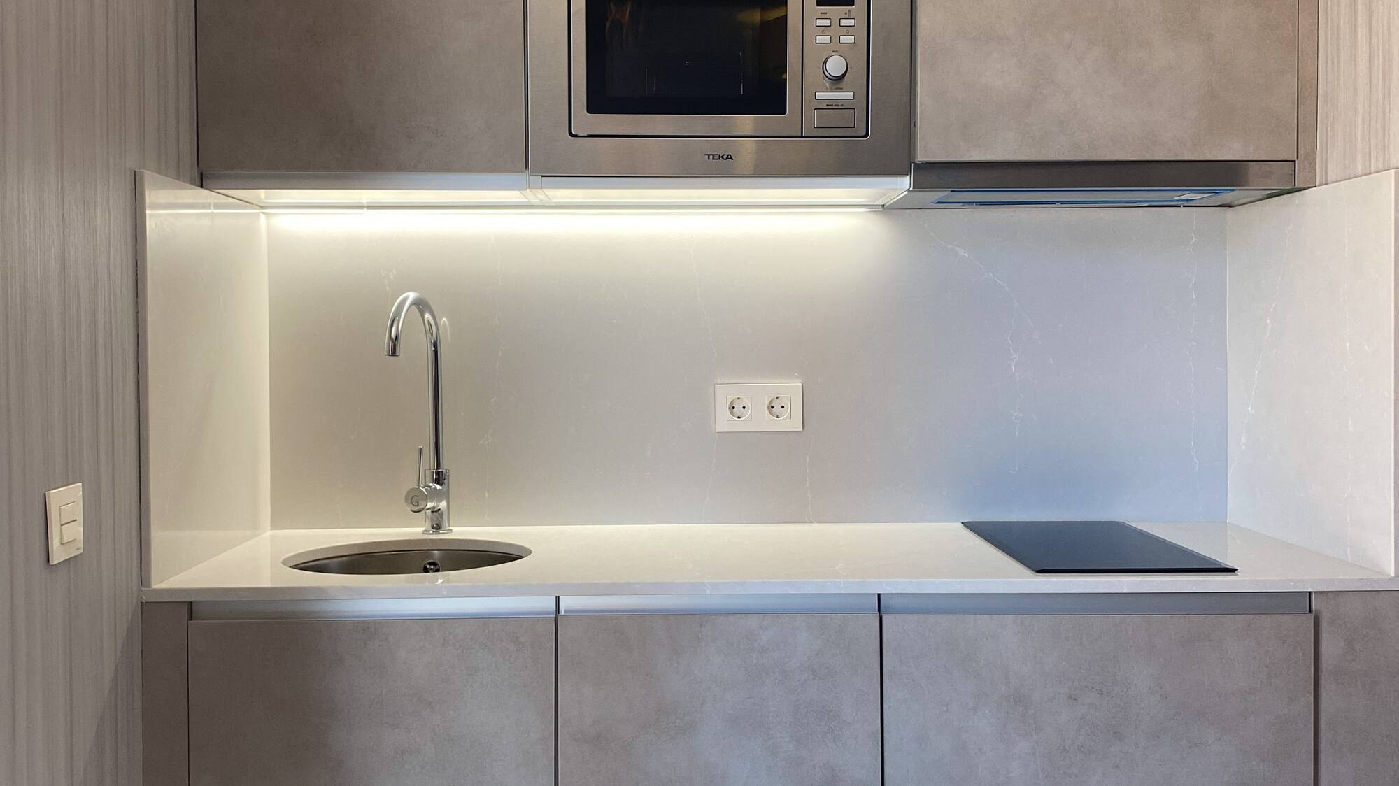 a kitchen with a microwave and sink