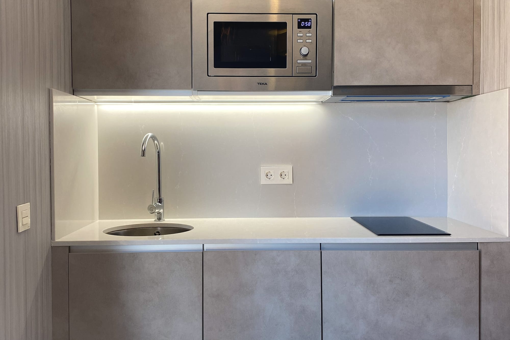 a kitchen with a microwave and sink