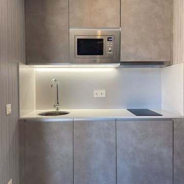a kitchen with a microwave and sink
