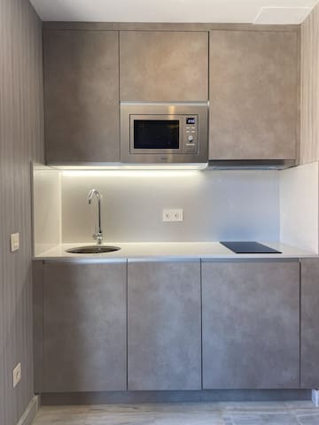 a kitchen with a microwave and sink