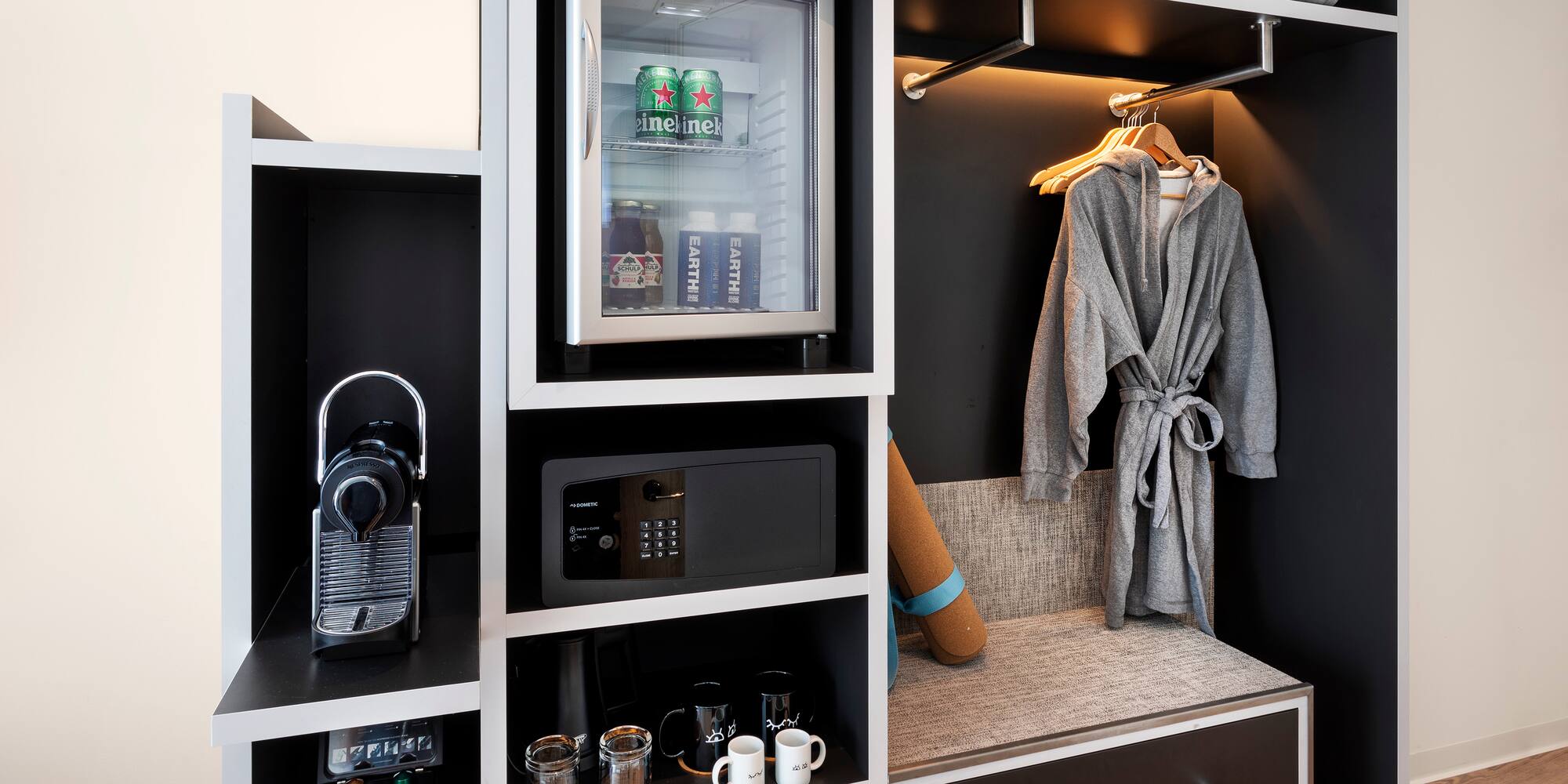 a room with a small refrigerator and a microwave