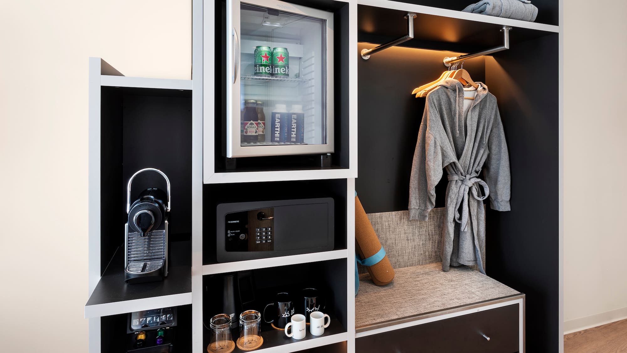 a room with a small refrigerator and a microwave