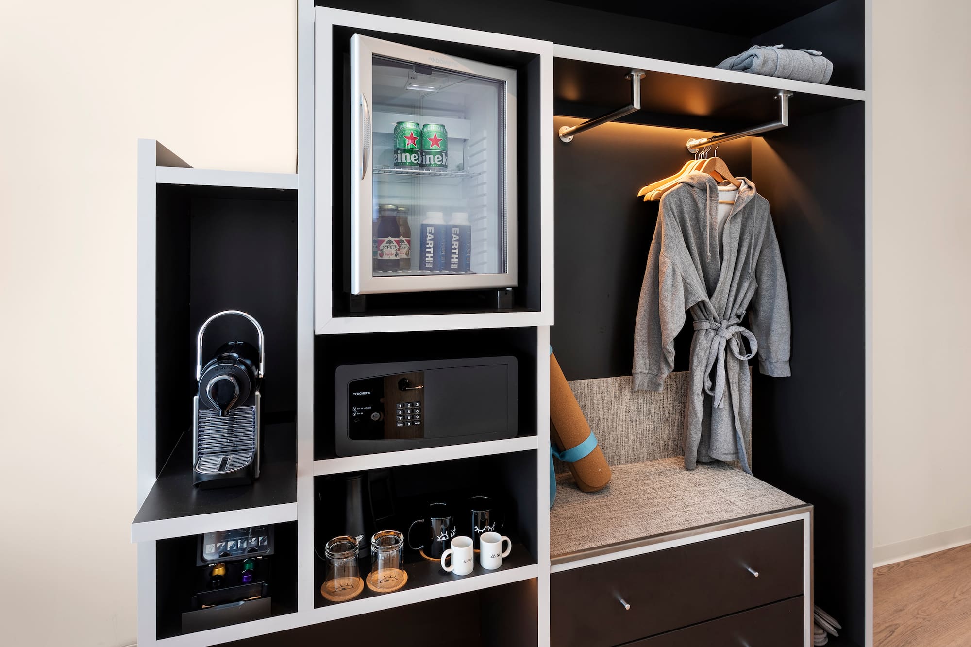 a room with a small refrigerator and a microwave