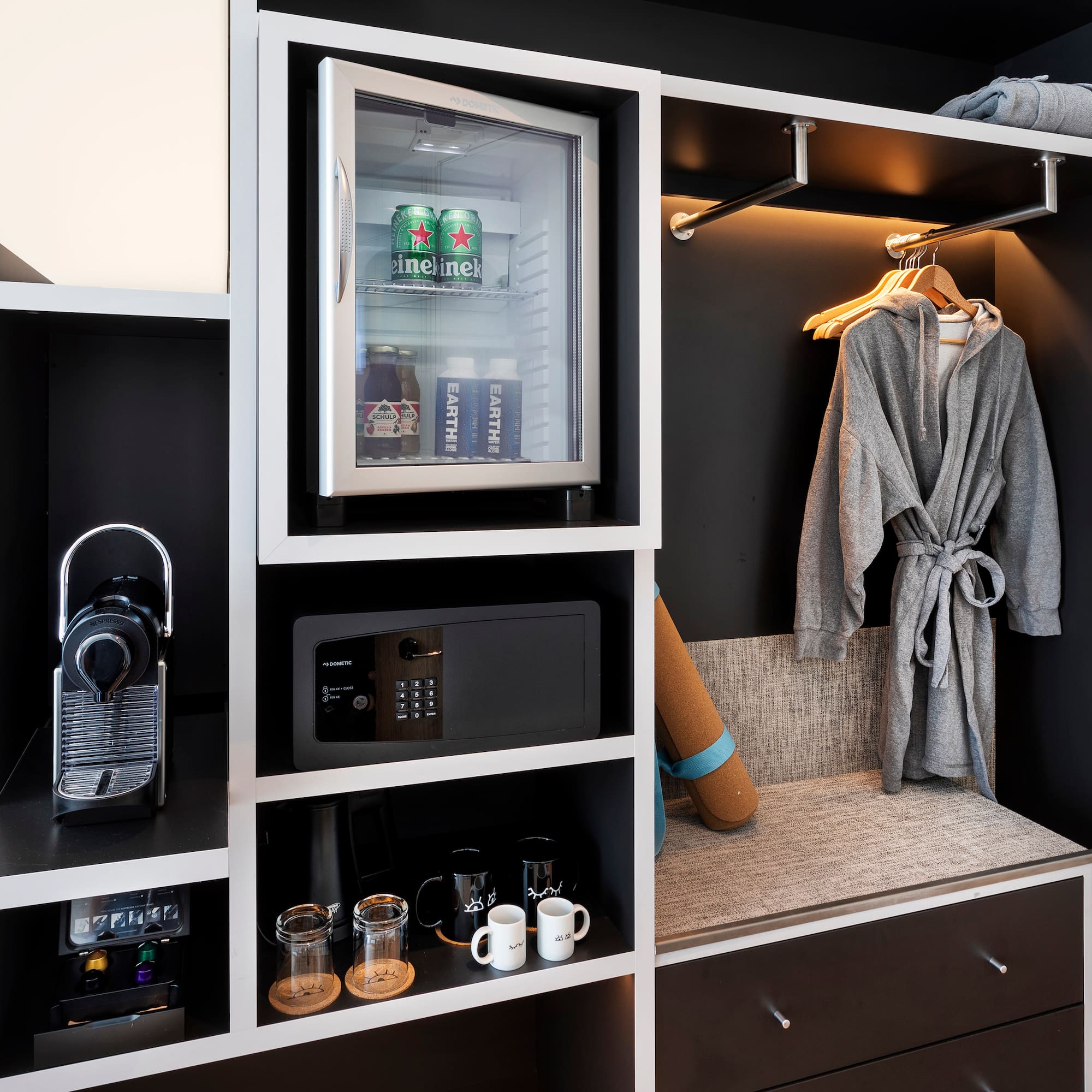 a room with a small refrigerator and a microwave