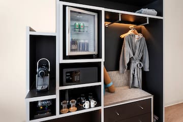 a room with a small refrigerator and a microwave