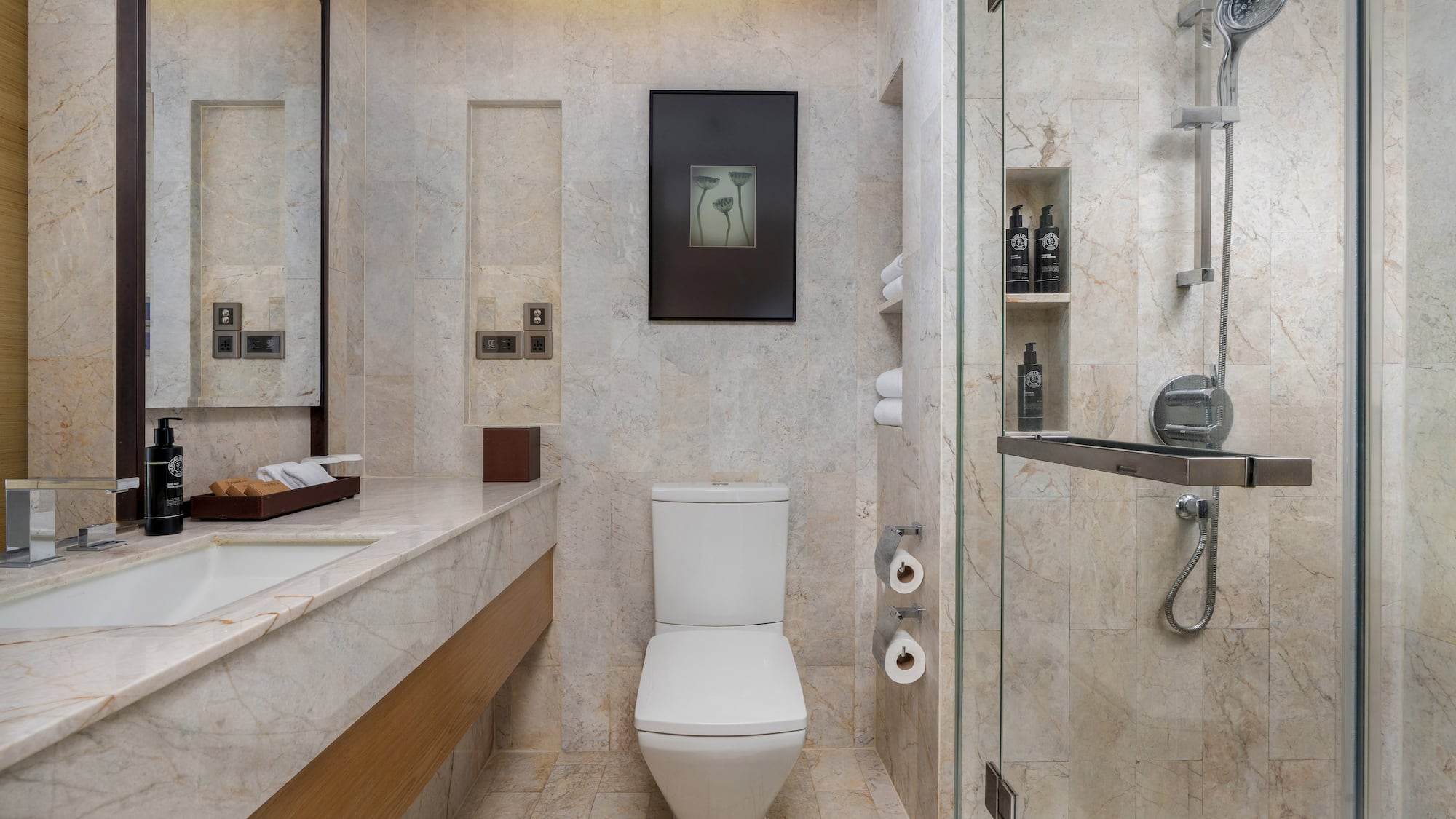 Modern marble bathroom featuring a white toilet, sink vanity, and glass shower. - Guest Room - The Hotel Bangkok Sukhumvit 26 Affiliated by Meliá, بانكوك
