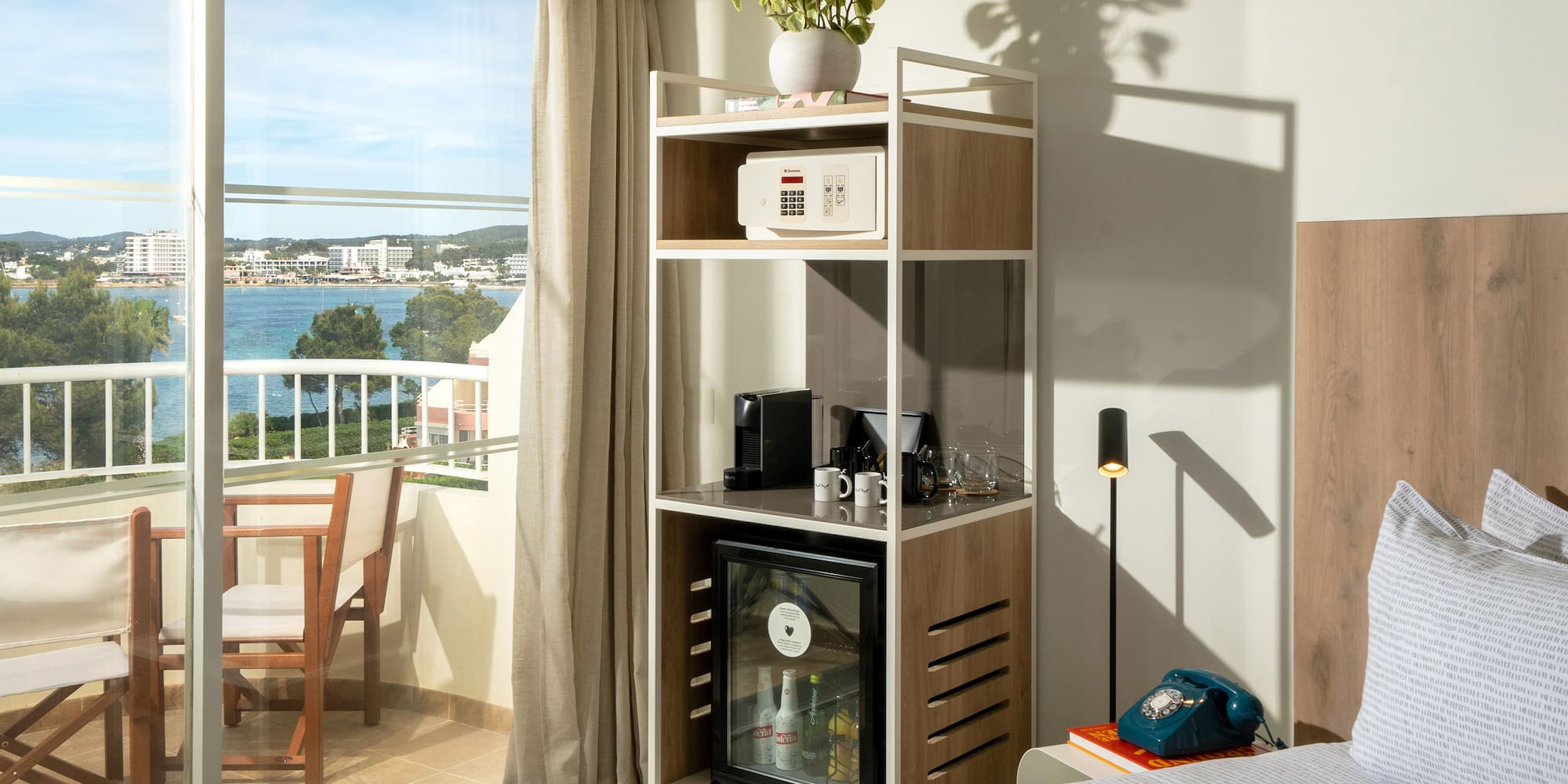 a room with a bed and a table and a television