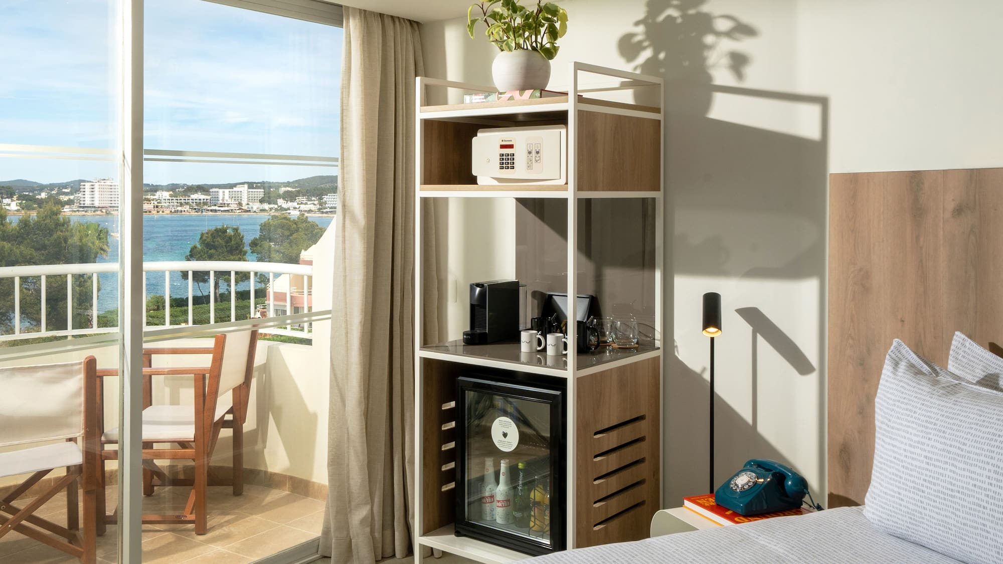 a room with a bed and a table and a television