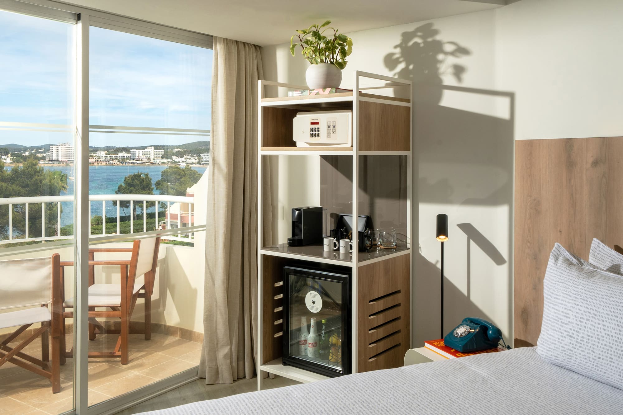 a room with a bed and a table and a television