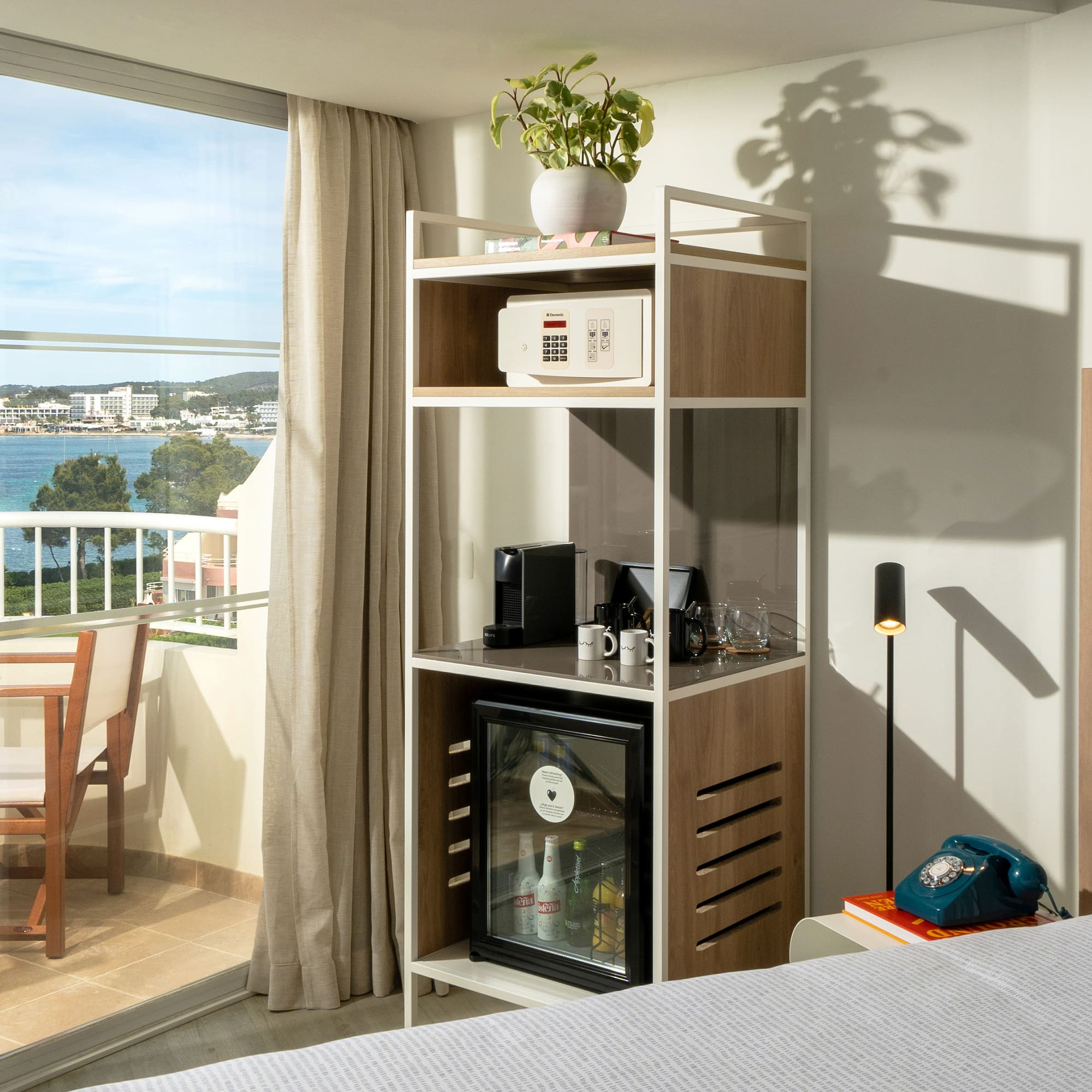 a room with a bed and a table and a television