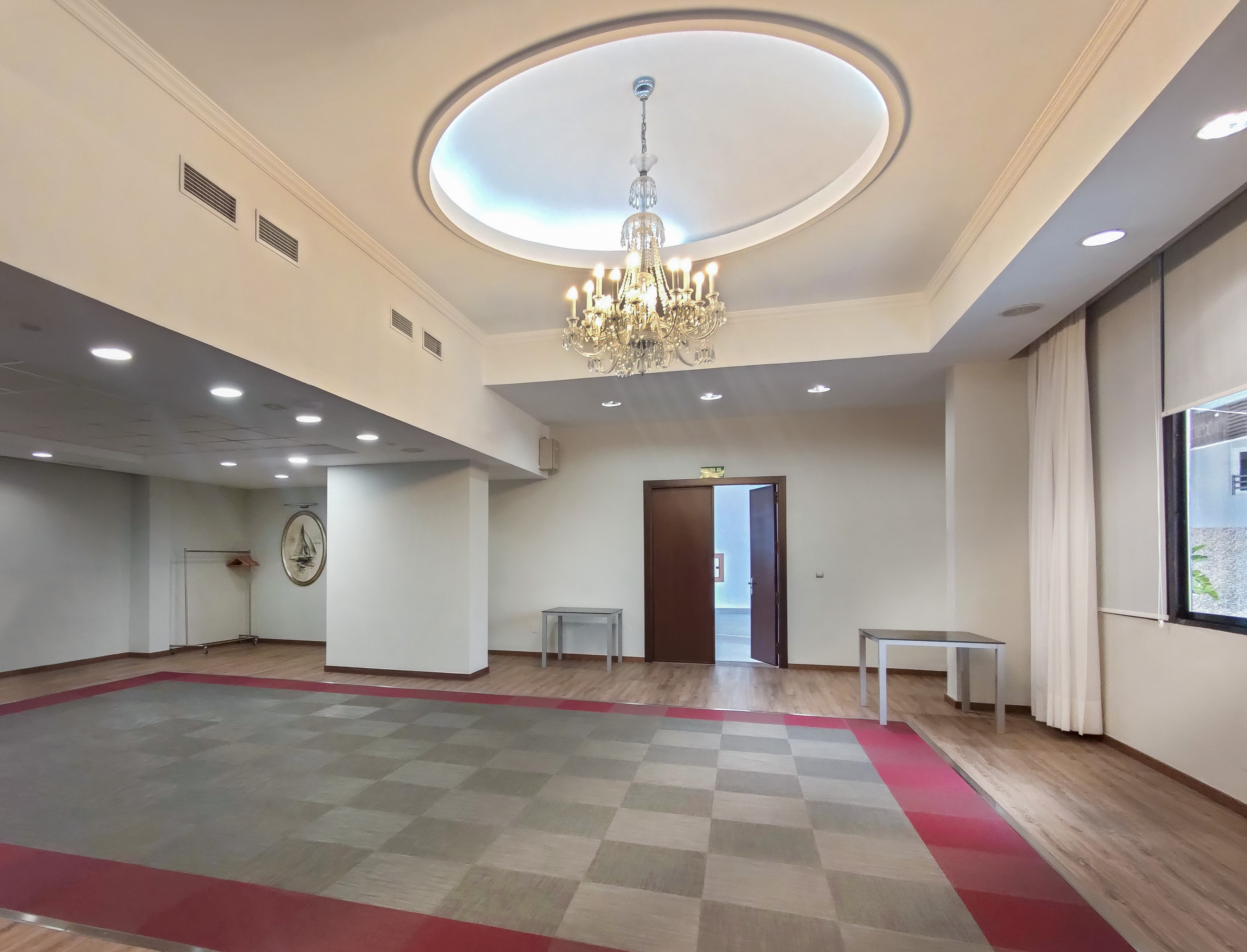a room with a chandelier and a checkered floor
