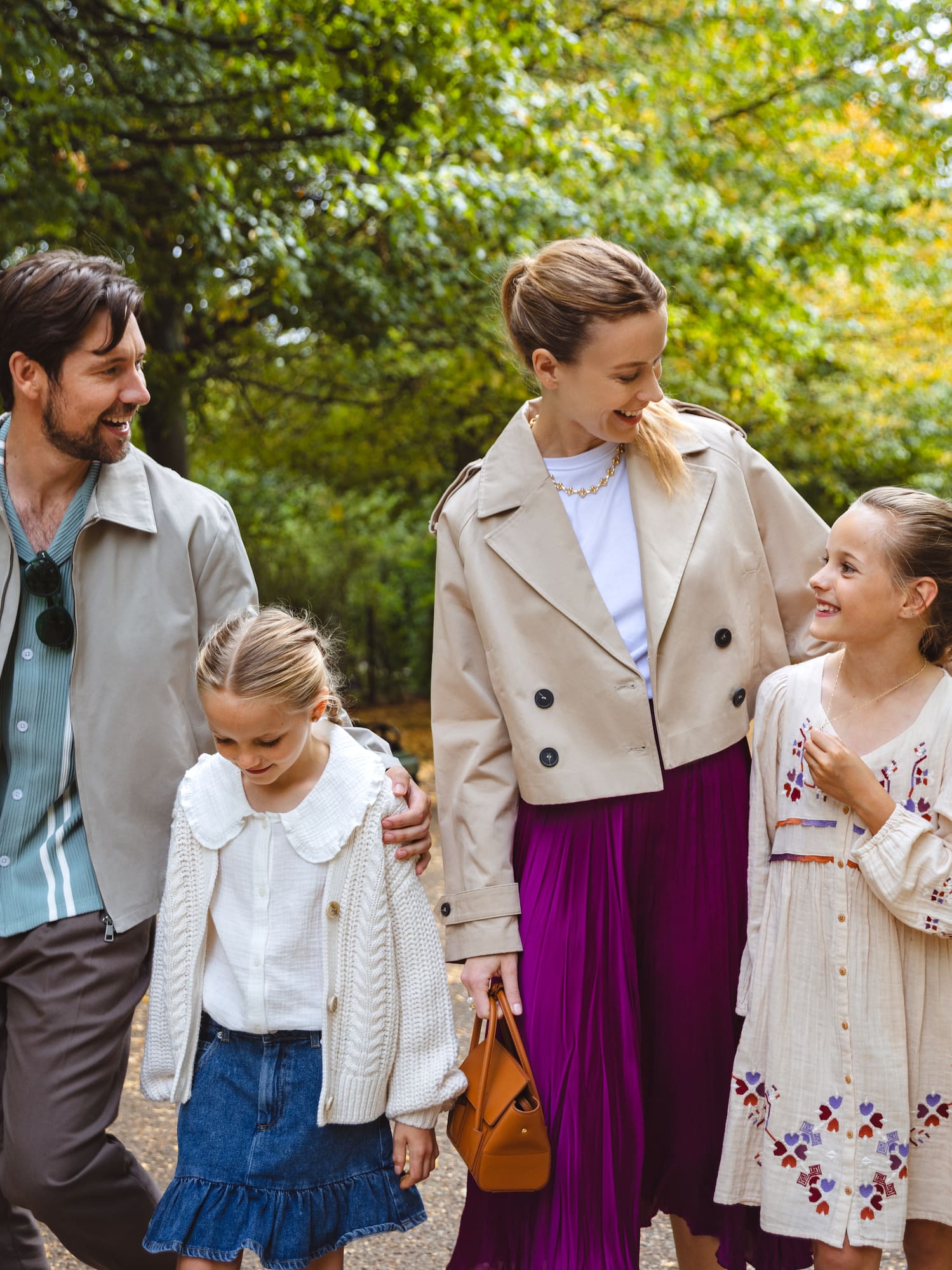 a man and woman walking with two girls