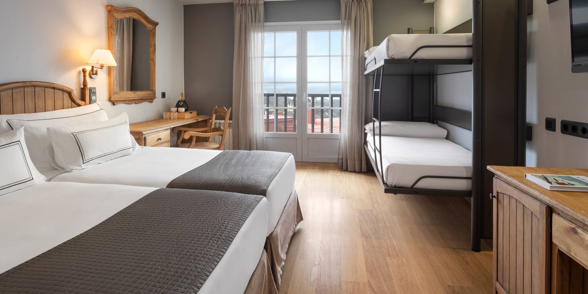 a room with bunk beds and a wood floor