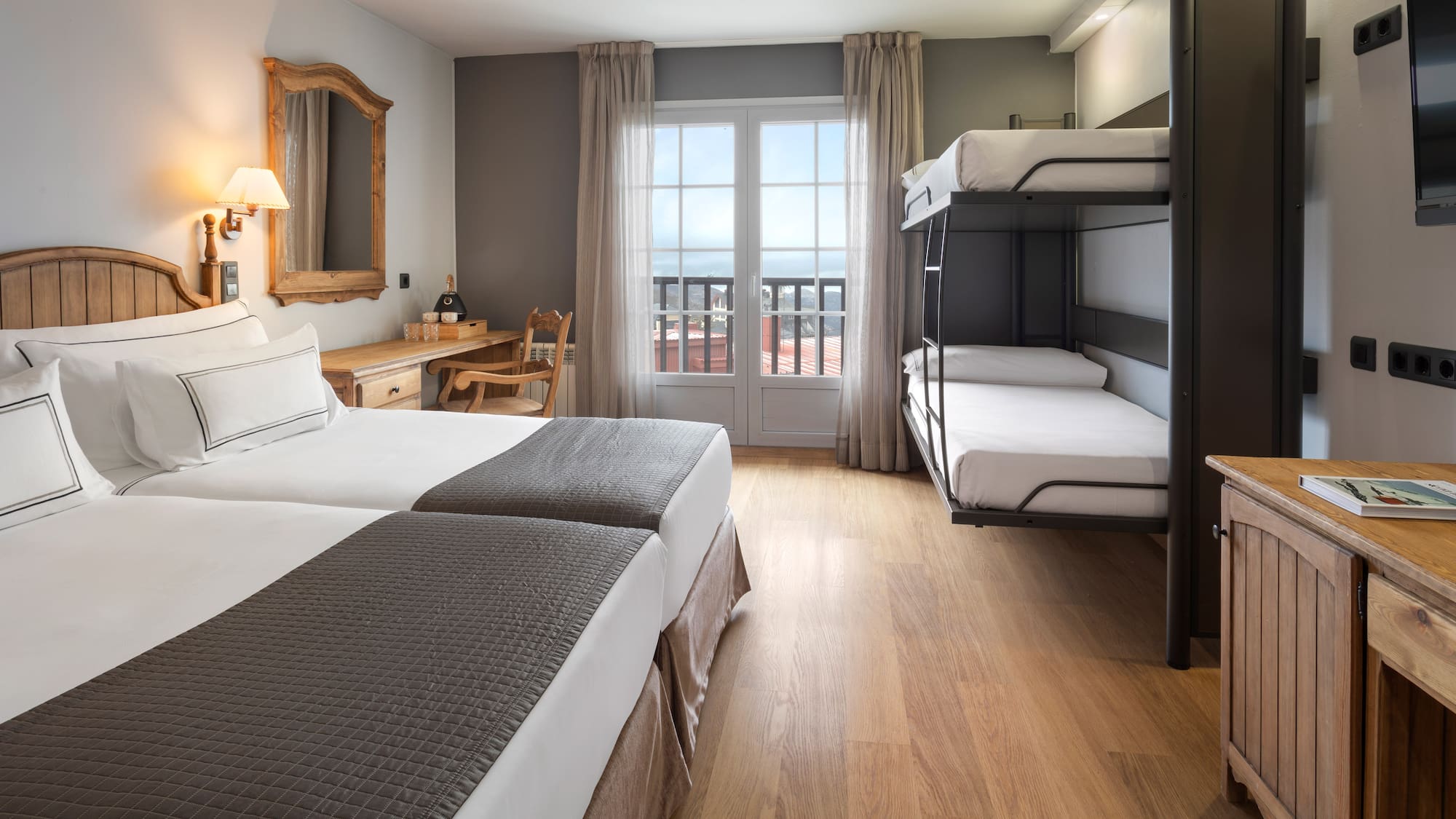 a room with bunk beds and a wood floor