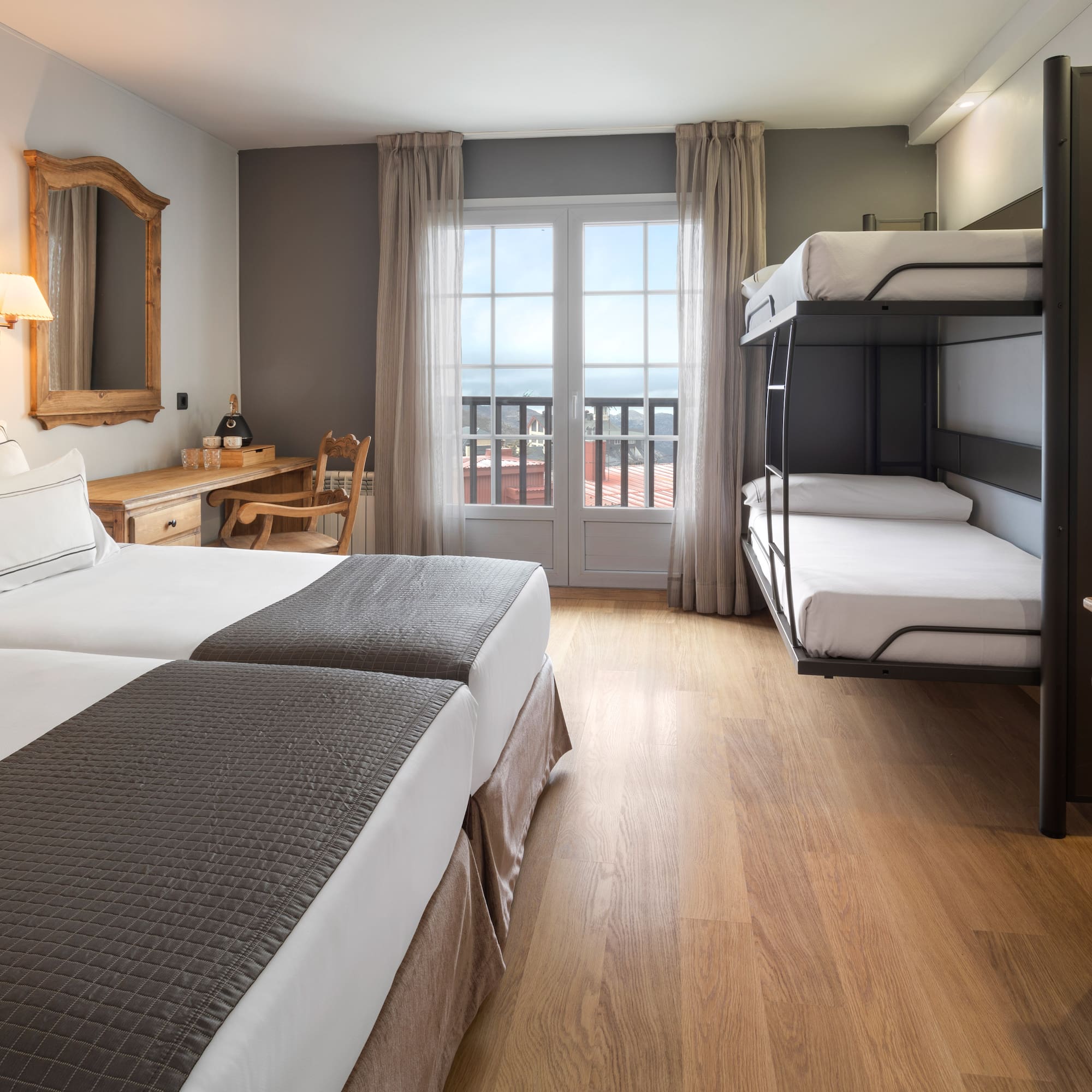 a room with bunk beds and a wood floor