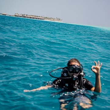 a person in a scuba suit in the ocean