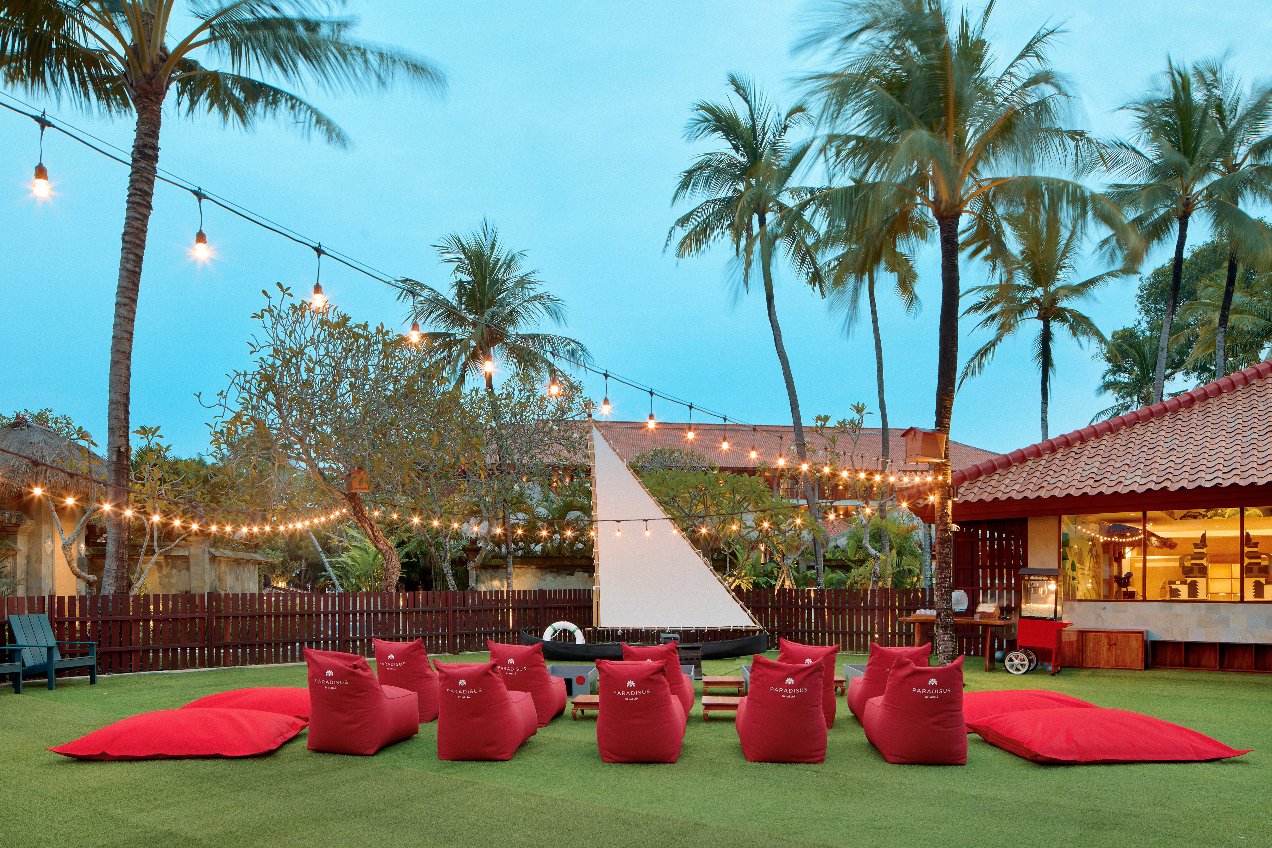 a group of red bean bags in a yard