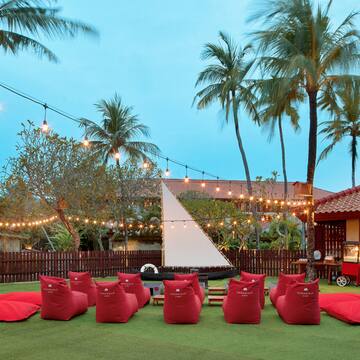 a group of red bean bags in a yard