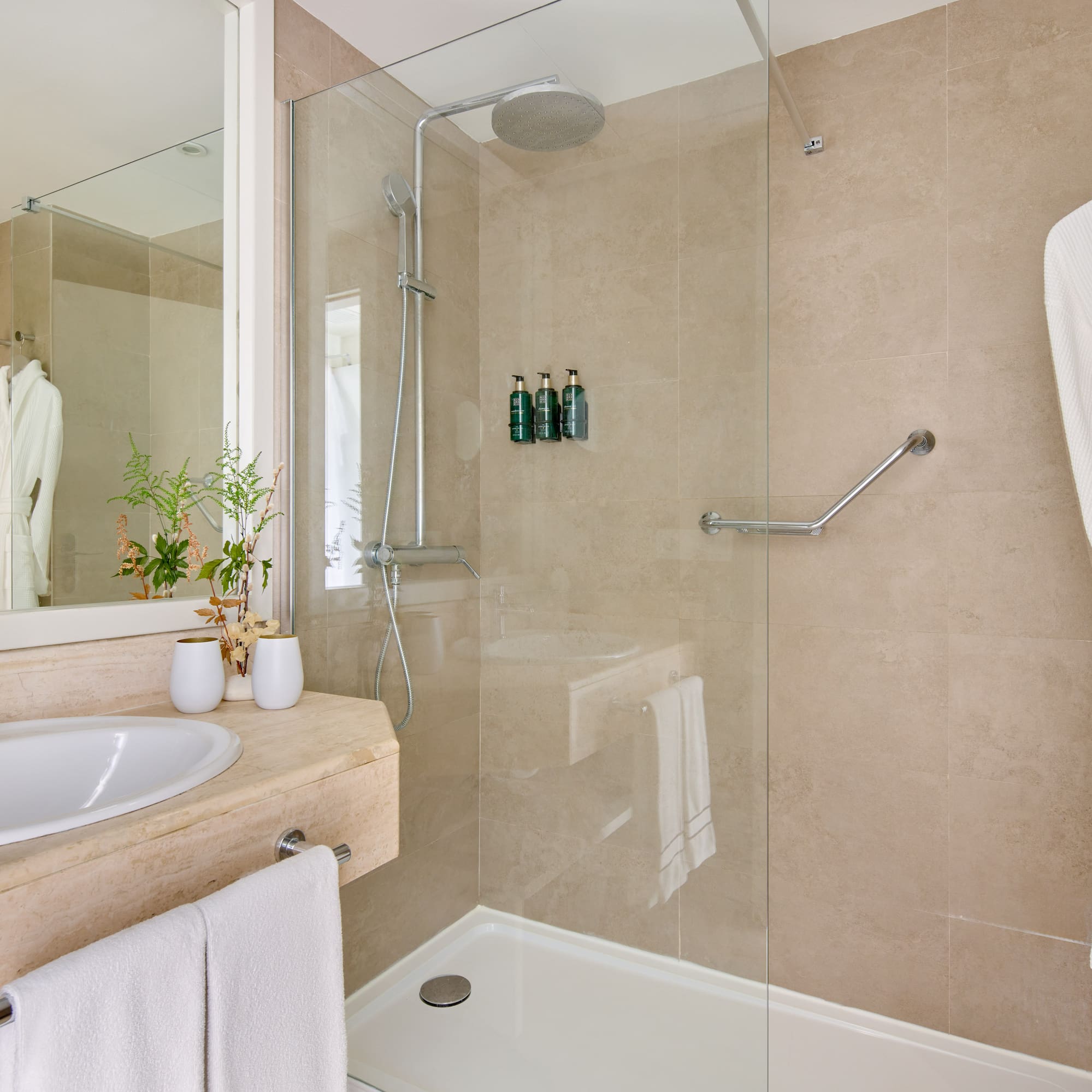 a bathroom with a glass shower and sink
