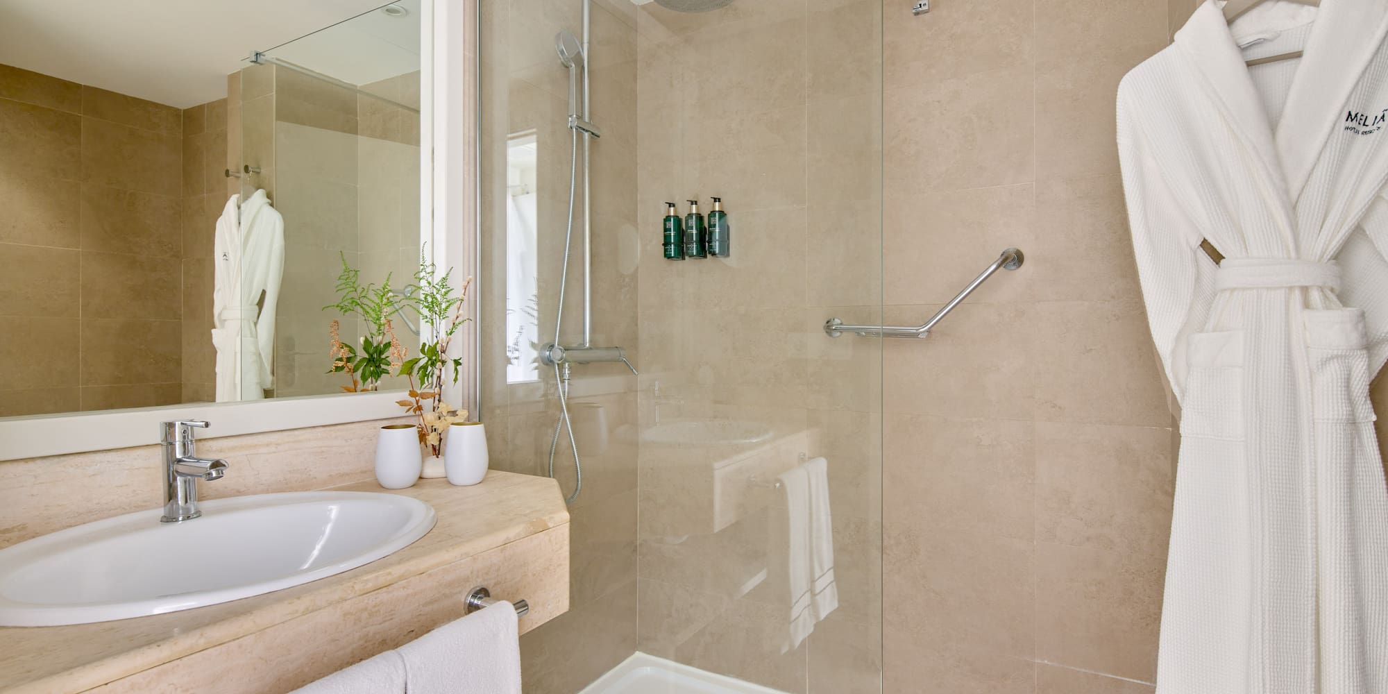 a bathroom with a glass shower and sink