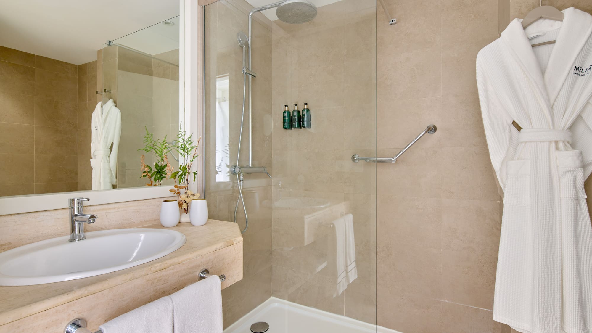 a bathroom with a glass shower and sink
