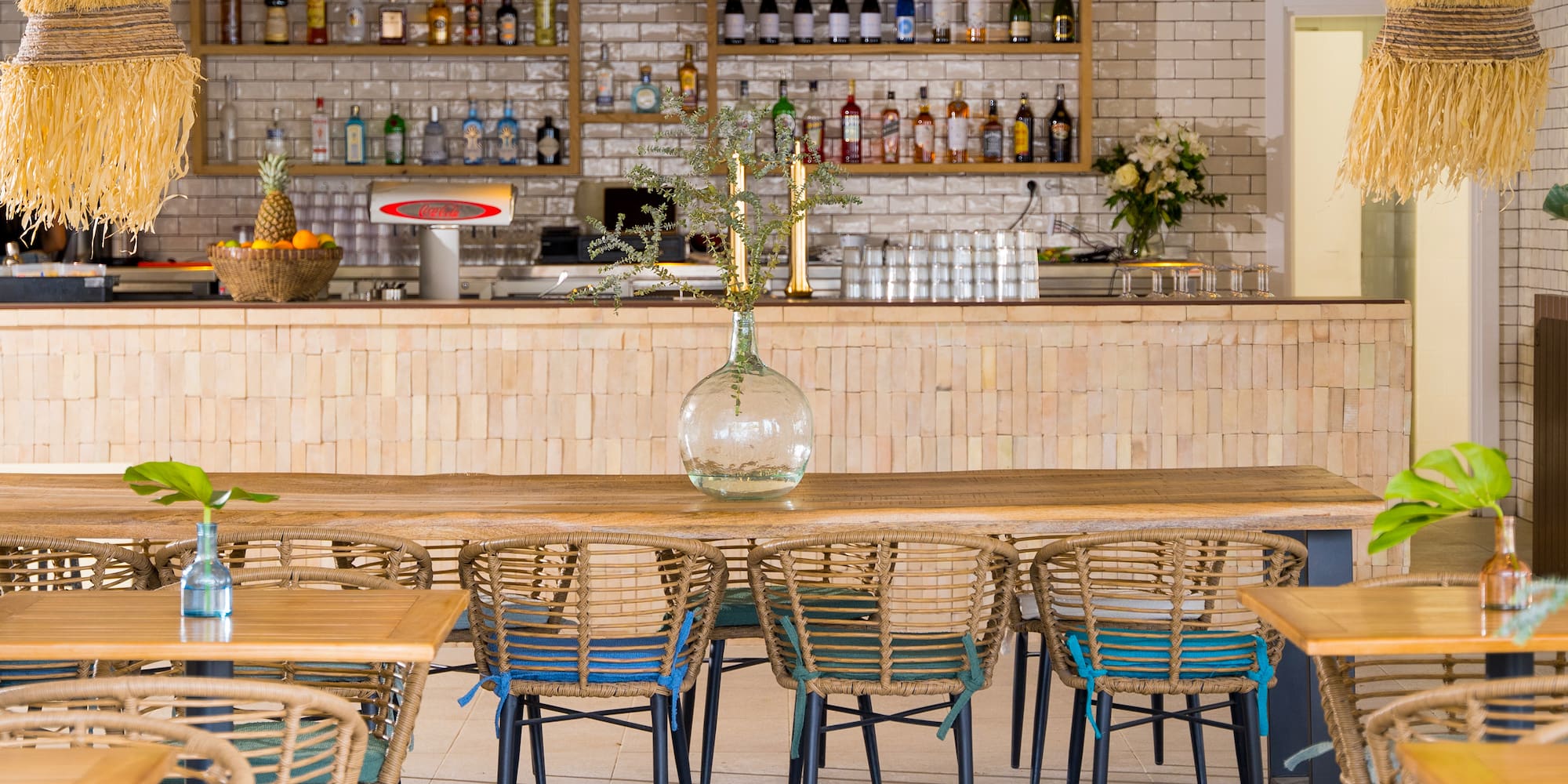 a table with chairs and a vase on it