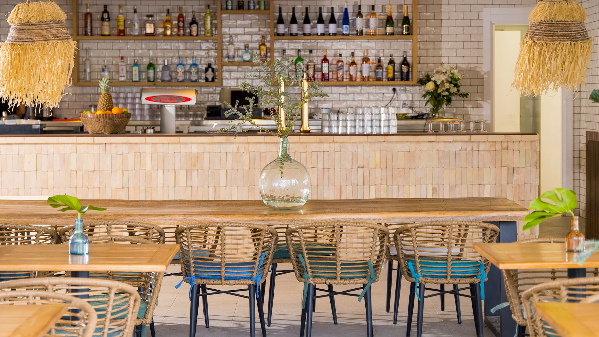 a table with chairs and a vase on it