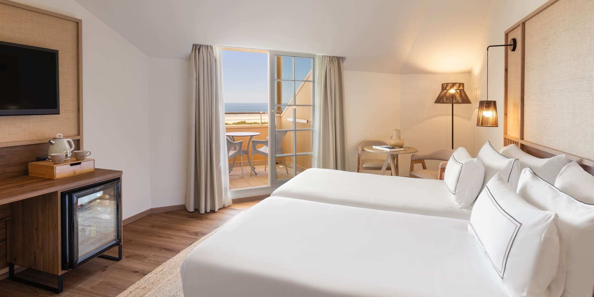 a room with two beds and a fireplace