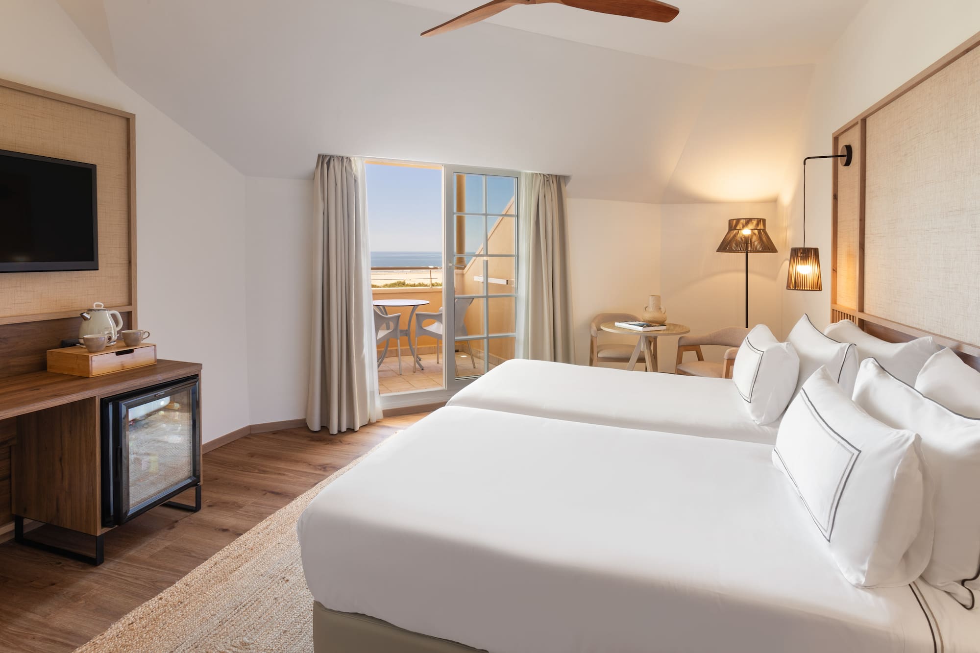 a room with two beds and a fireplace