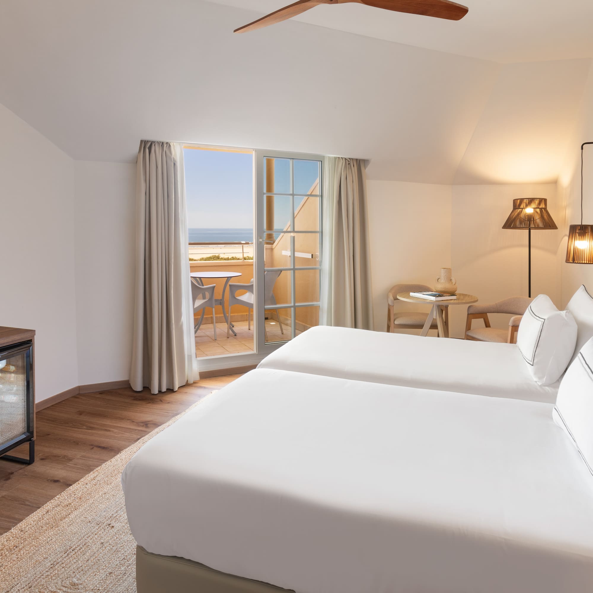 a room with two beds and a fireplace