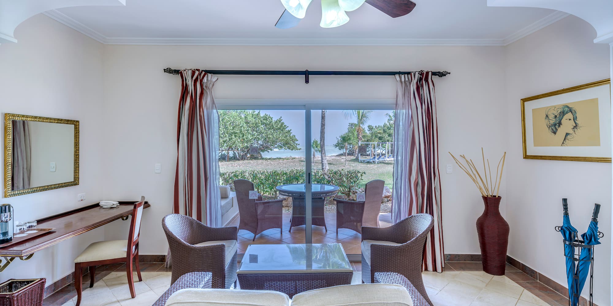 a living room with a fan and chairs
