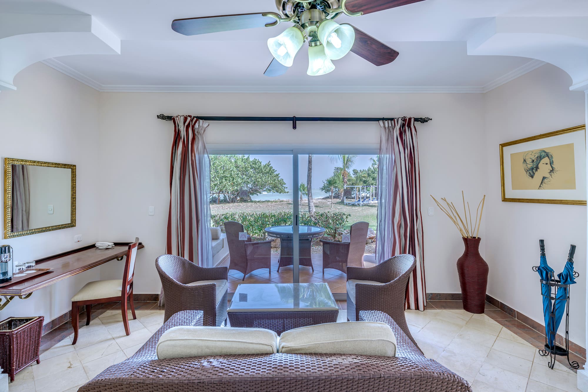 a living room with a fan and chairs
