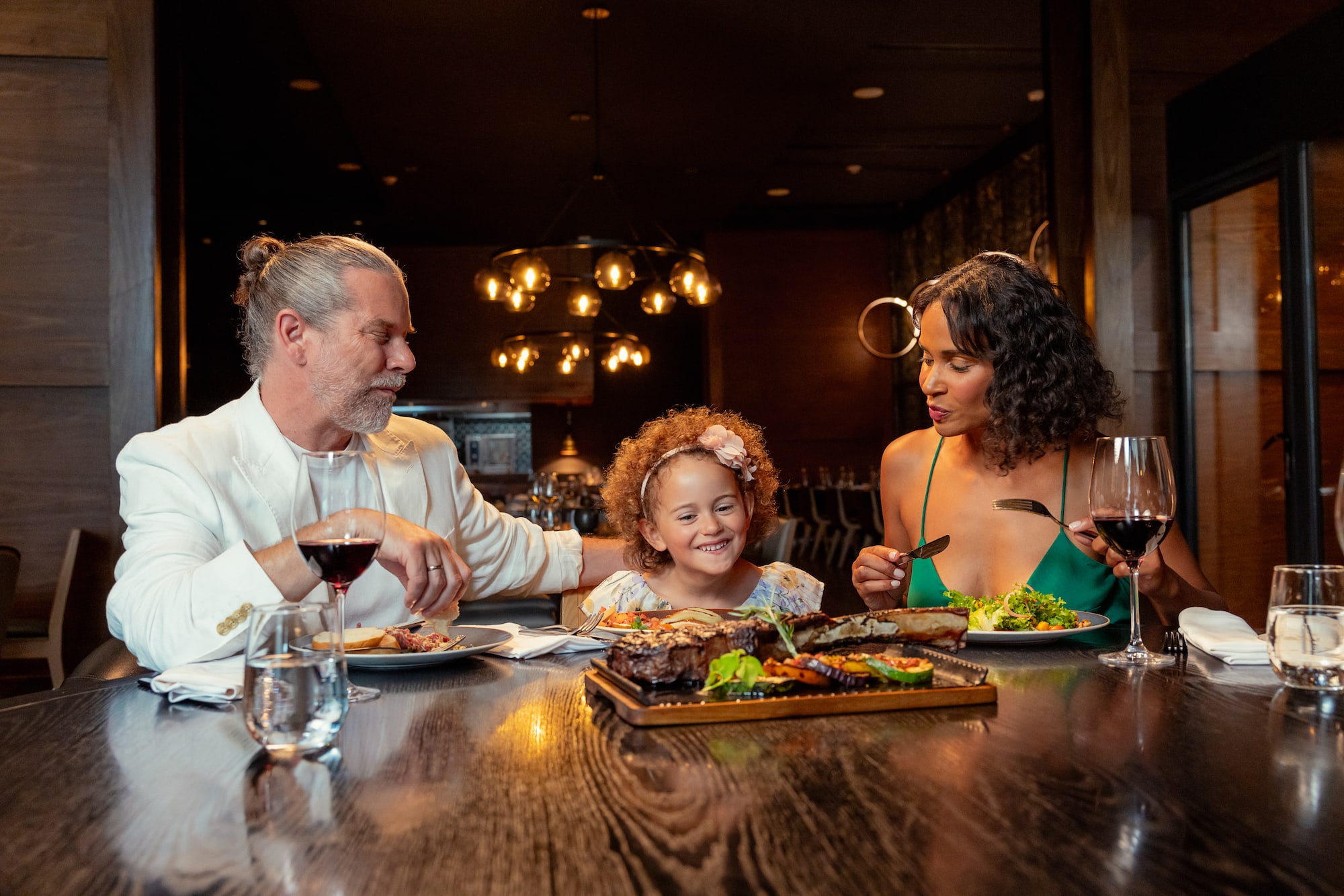 a group of people sitting at a table eating food