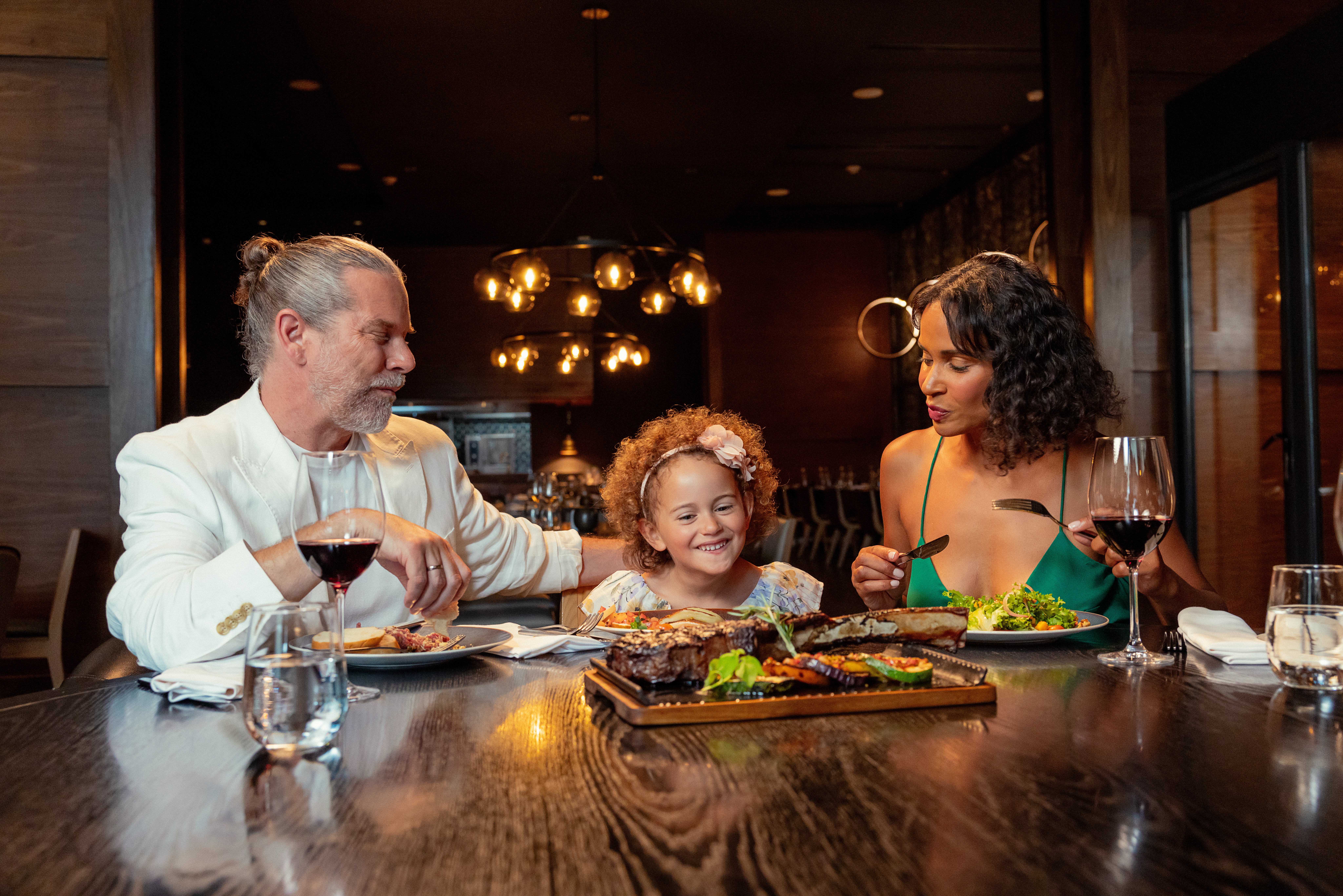 a group of people sitting at a table eating food