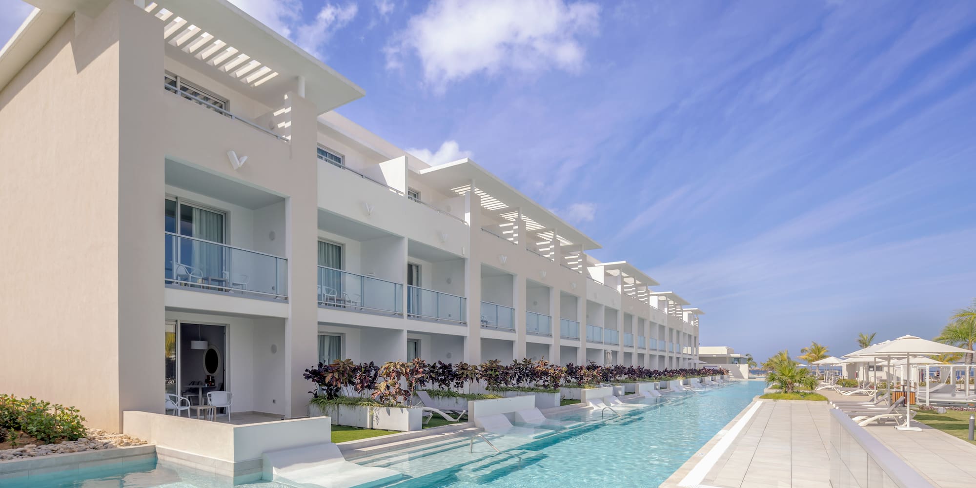a pool with a building and a blue sky