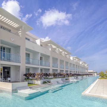 a pool with a building and a blue sky